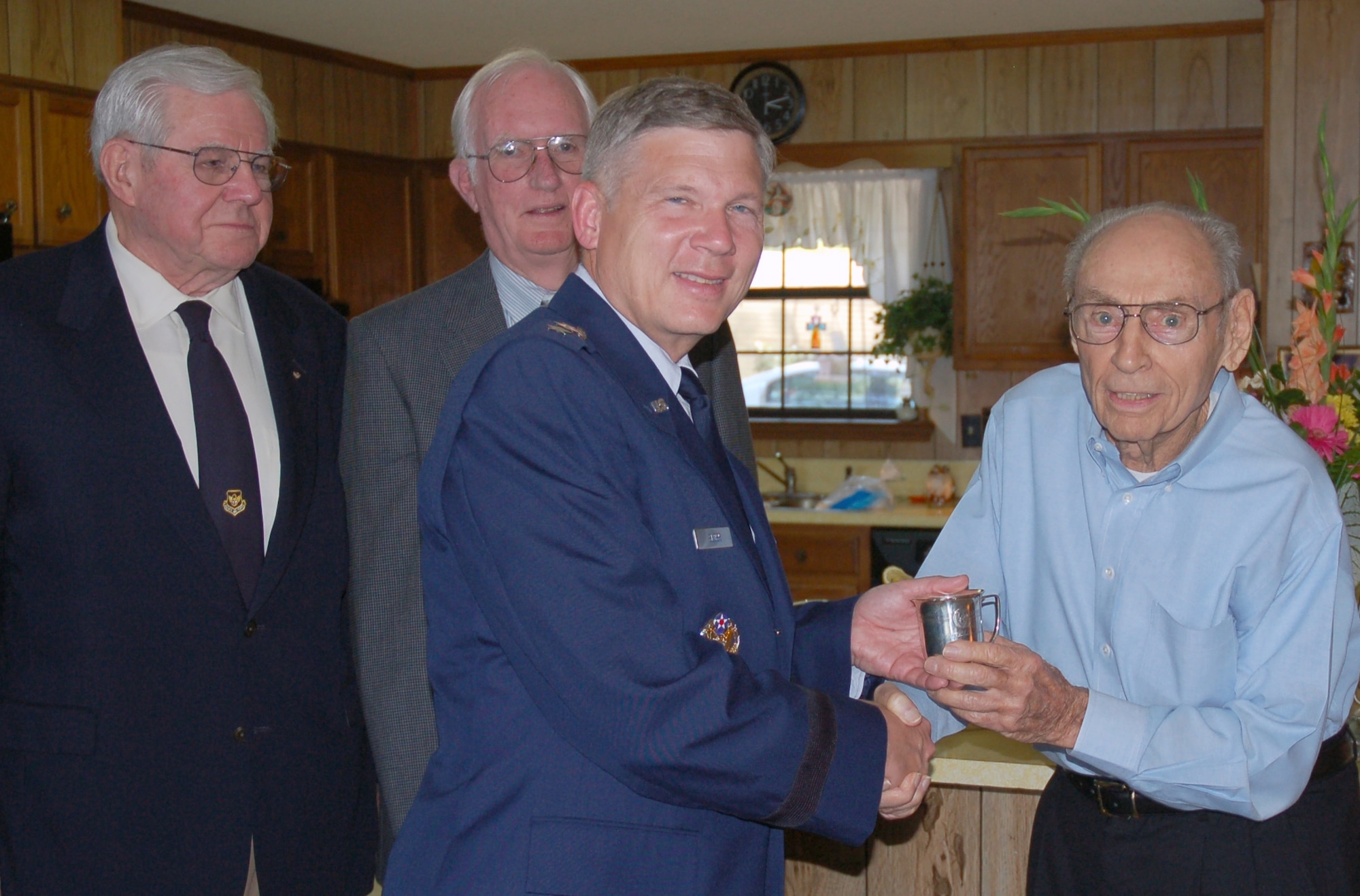 Lt. Gen. Robert J. Elder Jr., Eighth Air Force commander, accepts the donation of one of the nine Eaker Bowl cups from Mr. Charles Jones Jr. on Thursday, June 5th. Mr. Jones’ father, Lt. Col. (ret.) Charles Jones Sr., was one of the nine original members of the famous Castle Coombe Mess.  General Ira C. Eaker, who first commanded Eighth Air Force in England during World War II, established the Castle Coombe Mess, which purchased the Eaker Bowl and cups with the optimistic vision of conducting post-war reunions. The donation of the cup by Mr. Jones, who also served in World War II, is the fifth silver cup donated to Eighth Air Force, with the remaining four cups kept by the respective family members as a cherished memento of their link to World War II history. General Elder was accompanied by two former Eighth Air Force commanders, Lt. Gen. (ret.) E.G. "Buck" Shuler Jr. and Lt. gen. (ret.) Edgar S. Harris Jr., who originally accepted the donation of the bowl, ladle, and his cup from General Eaker in 1981. The Eaker Bowl is a physical piece of the Mighty Eighth’s history which occupies a place of honor at Eighth Air Force headquarters as a heraldic symbol of sterling service to the nation, comradeship, and optimism about the future by those who have served with The Mighty Eighth. (U.S. Air Force Photo by Capt. Rob Goza)