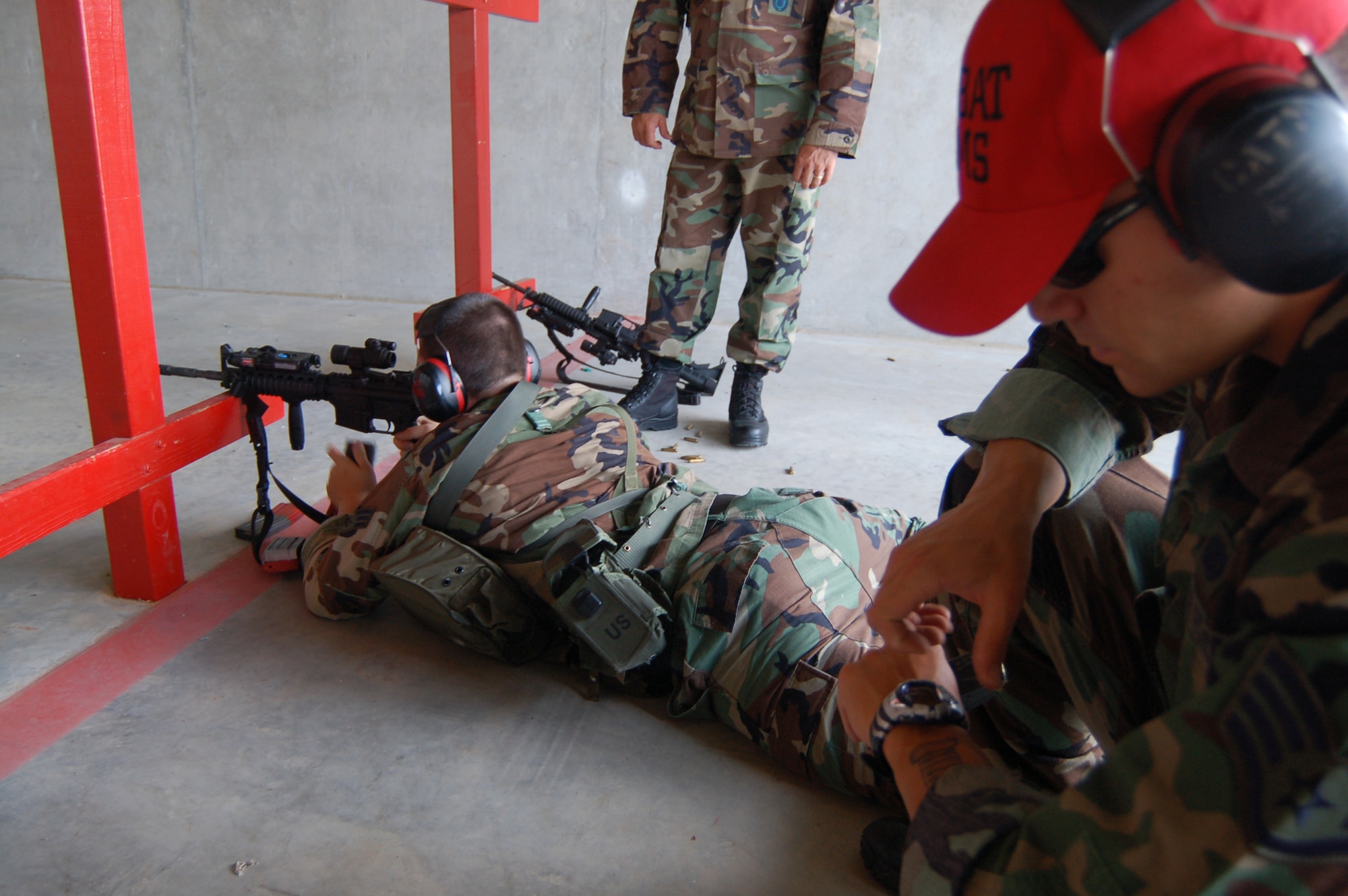 Senior Airman Waylon Munson, 436th Security Forces Squadron response force leader, fires his M-4 rifle in relay-firing drill in preparation for 2007 Air Mobility Command Rodeo, as Staff Sgt. Dustin McPhillips, 436th SFS team leader, times the drill. In addition to precision and accuracy, speed and fitness are also graded in the Rodeo. (U.S. Air Force photo/Tech. Sgt. Kevin Wallace)
