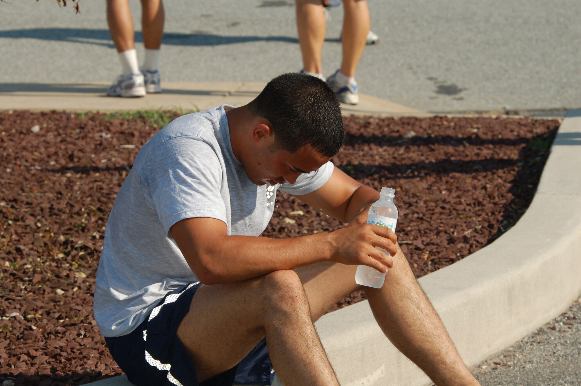 Airman James Parry, 436th Medical Dental Operations Squadron, cools off and rehydrates after the Warrior Run. (U.S. Air Force photo/Tech. Sgt. Kevin Wallace)