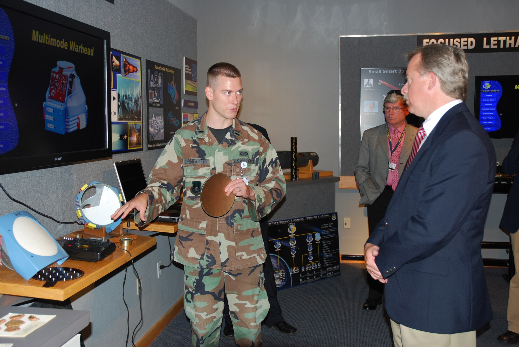 EGLIN AIR FORCE BASE, Fla. -- First Lieutenant Ryan Drinkwater explains the operation of the Multimode Warhead to Florida Lieutenant Governor Jeff Kottkamp during his visit to the Air Force Research Laboratory Technology Display Center July 18. (Air Force photo by Mike Wallace).

 
