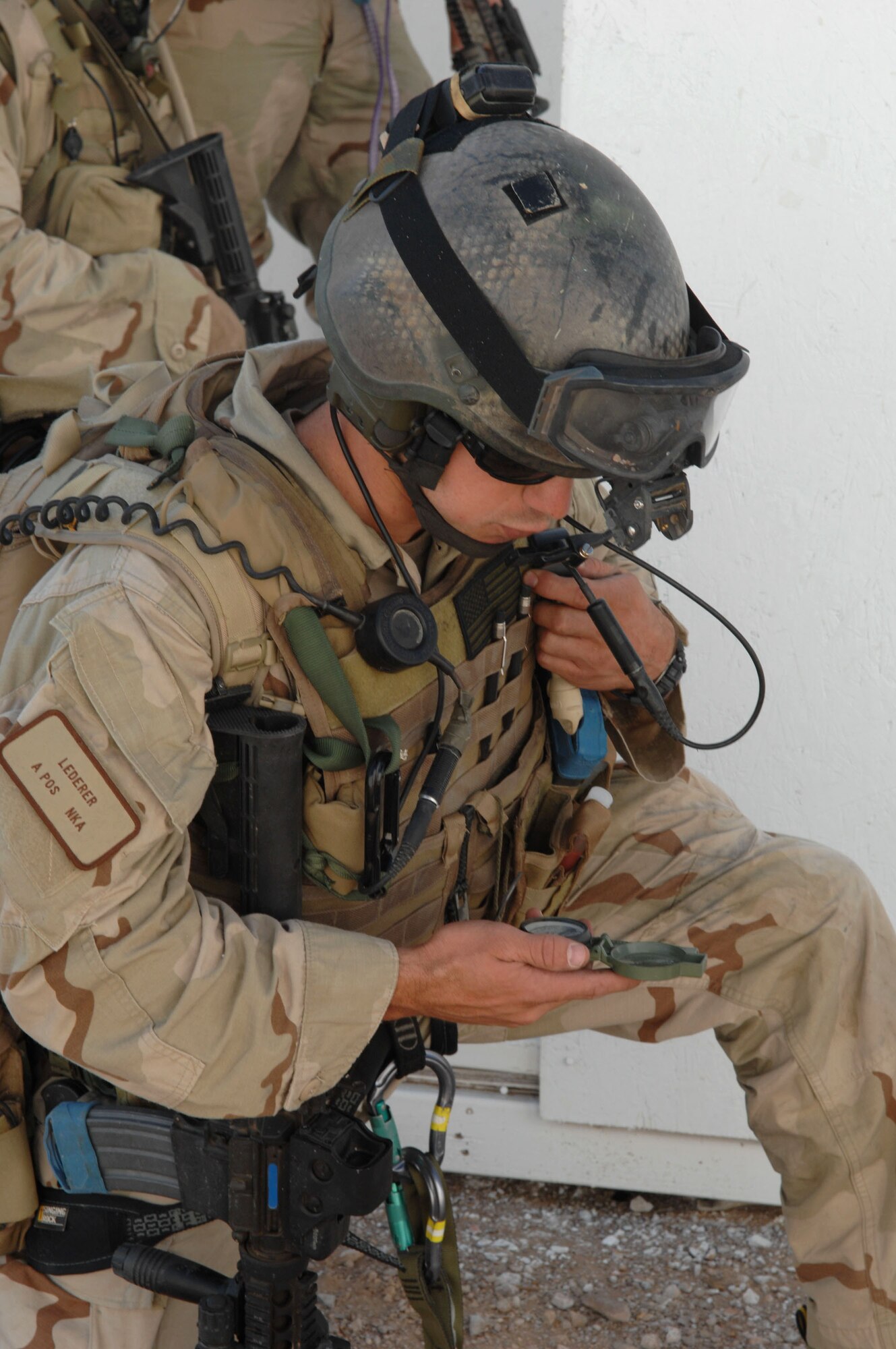 Capt. Eric Lederer relays information for a call for fire as his fellow rescueman provides cover during Exercise Angel Thunder July 16 at Gila Bend, Ariz. Captain Lederer is a 48th Rescue Squadron combat pararescue officer from Davis-Monthan Air Force Base, Ariz. The exercise is designed to provide realistic combat search and rescue training for Airmen in combat rescue forces. (U.S. Air Force photo/Staff Sgt. Lanie McNeal) 
