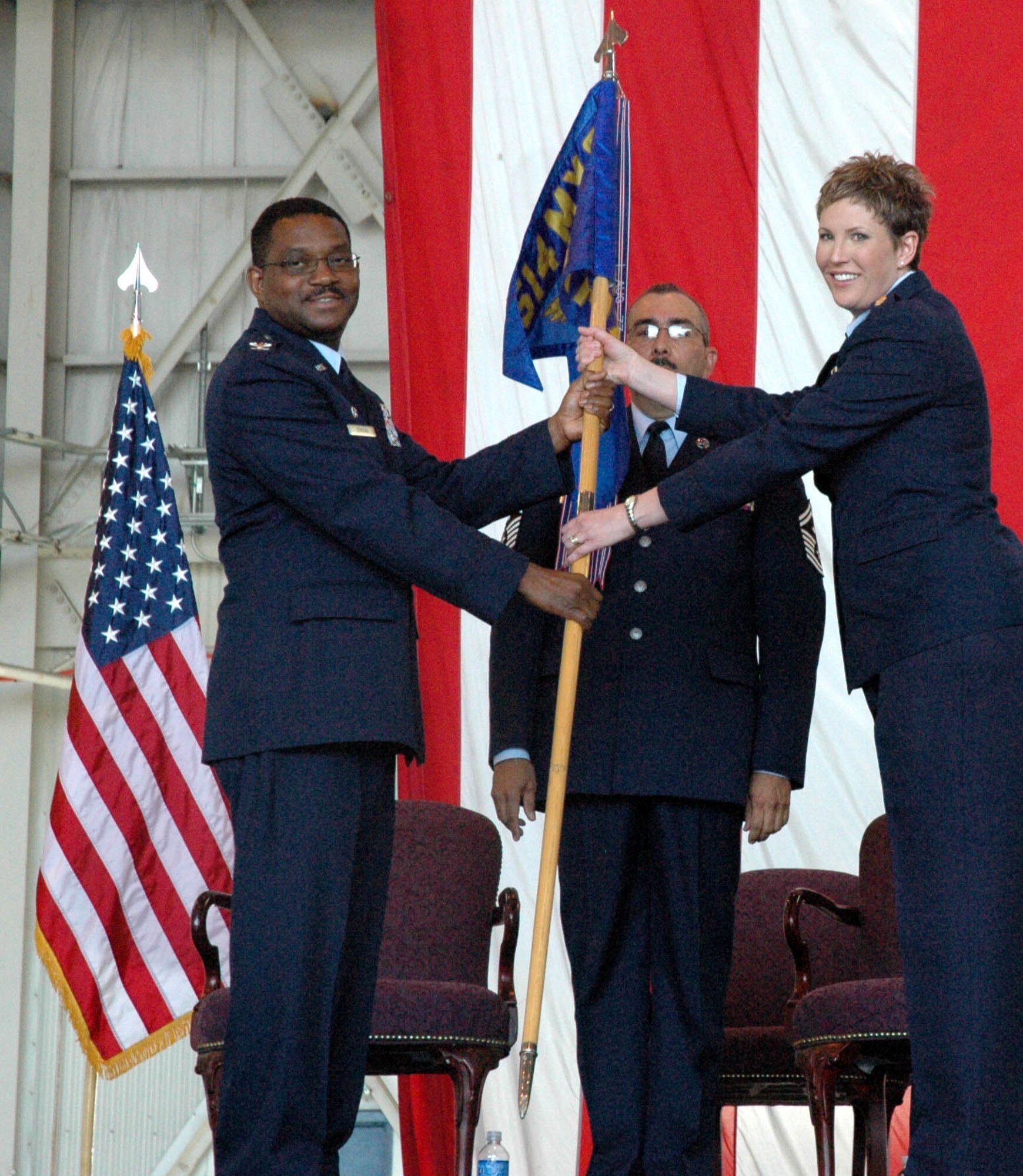 MCGUIRE AIR FORCE BASE, N.J. -- Maj. Kerri Ebrecht, right, accepts command of an Air Force Reserve Maintenance Squadron from Col. Regionald Stroud, commander, 514th Maintenance Group. Major Ebrecht was one-of-three officers to receive command, Sunday during a historic first-ever triple change-of-command ceremony held here in the 514th Air Mobility Wing. U.S Air Force photo/Master Sgt. Donna T. Jeffries