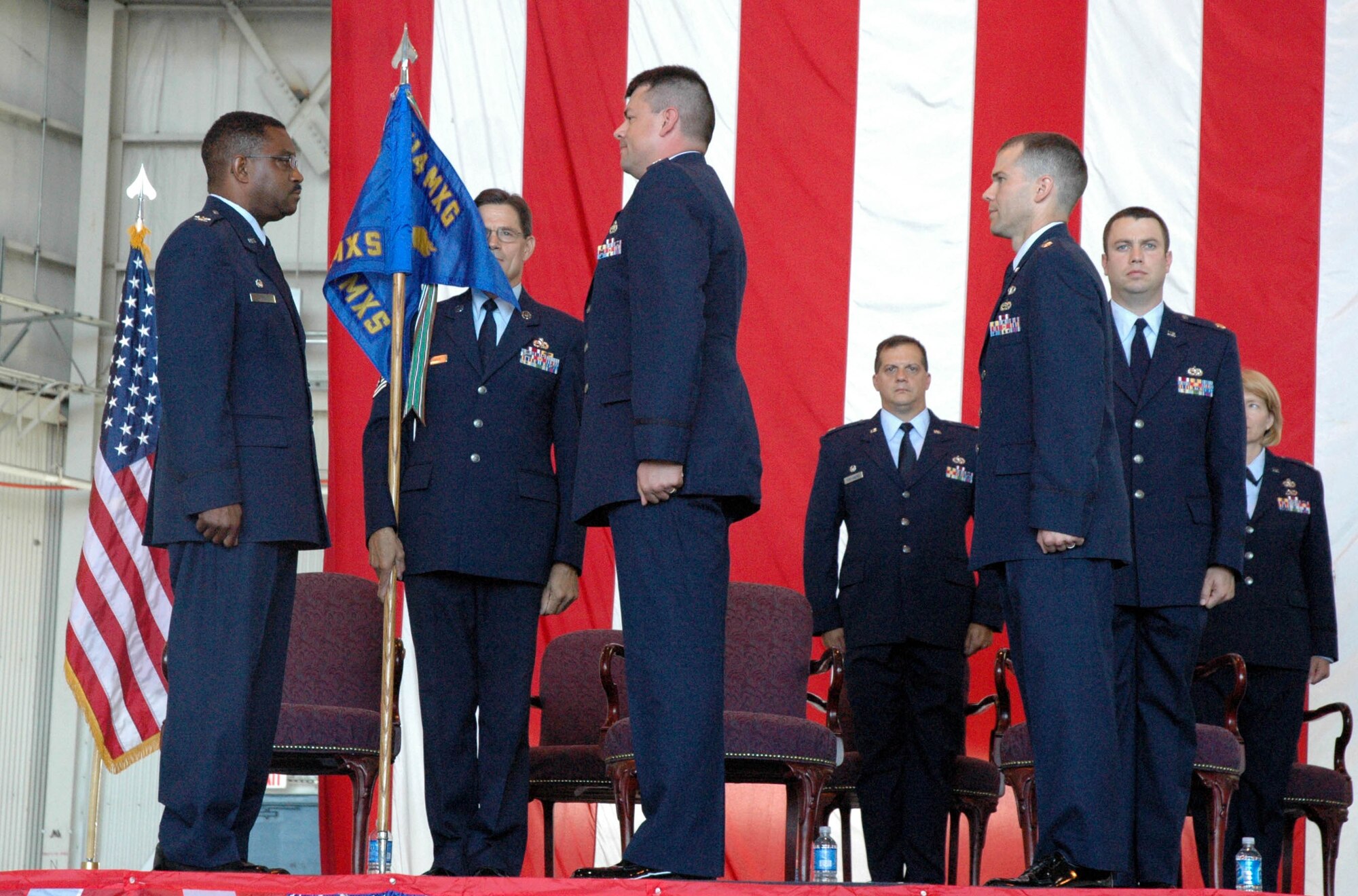 MCGUIRE AIR FORCE BASE, N.J. -- Lt. Col. Troy D. Vokes, front center, accepts command of an Air Force Reserve Maintenance Squadron from Col. Regionald Stroud, commander, 514th Maintenance Group. Colonel Vokest was one-of-three officers to receive command, Sunday during a historic first-ever triple change-of-command ceremony held here in the 514th Air Mobility Wing. U.S Air Force photo/Master Sgt. Donna T. Jeffries