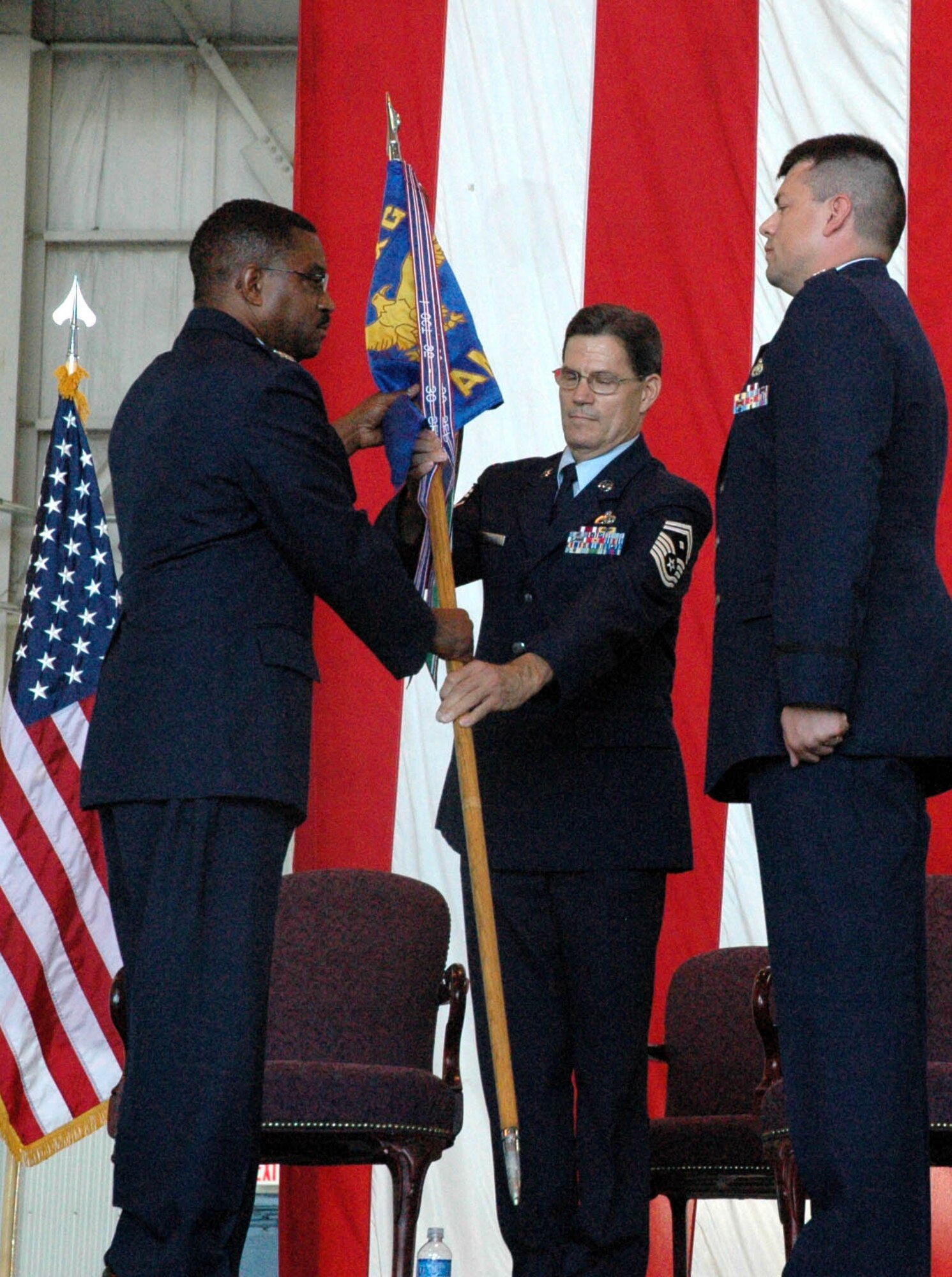 MCGUIRE AIR FORCE BASE, N.J. -- Lt. Col. Troy Vokes, right, accepts command of an Air Force Reserve Maintenance Squadron from Col. Regionald Stroud, commander, 514th Maintenance Group. Colonel Vokes was one-of-three officers to receive command, Sunday during a historic first-ever triple change-of-command ceremony held here in the 514th Air Mobility Wing. U.S Air Force photo/Master Sgt. Donna T. Jeffries