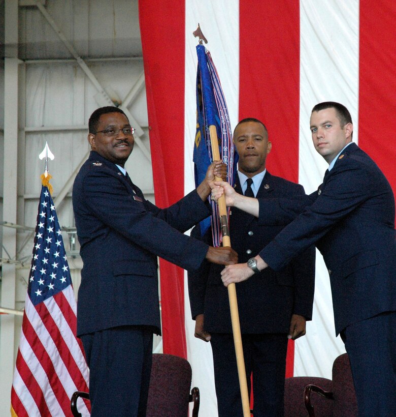 MCGUIRE AIR FORCE BASE, N.J. -- Maj. Jeff Matthew, right, accepts command of an Air Force Reserve Maintenance Squadron from Col. Regionald Stroud, commander, 514th Maintenance Group. Major Matthew was one-of-three officers to receive command, Sunday during a historic first-ever triple change-of-command ceremony held here in the 514th Air Mobility Wing. U.S Air Force photo/Master Sgt. Donna T. Jeffries