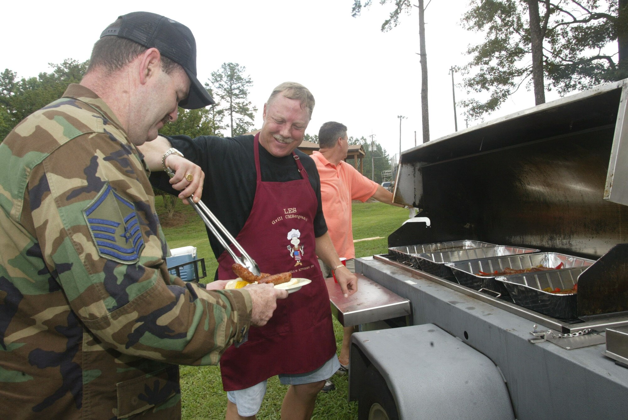 Chief Master Sgt. Les Davy, of the 22nd Air Force, at Dobbins Air Reserve Base, Ga., manned one of the many grills at the annual Corn and Sausage Roast held July 18 at the Lakeside Pavilion. The event raised more than $2,000 for Family Support's emergency funds. (U.S. Air Force photo/Don Peek)
