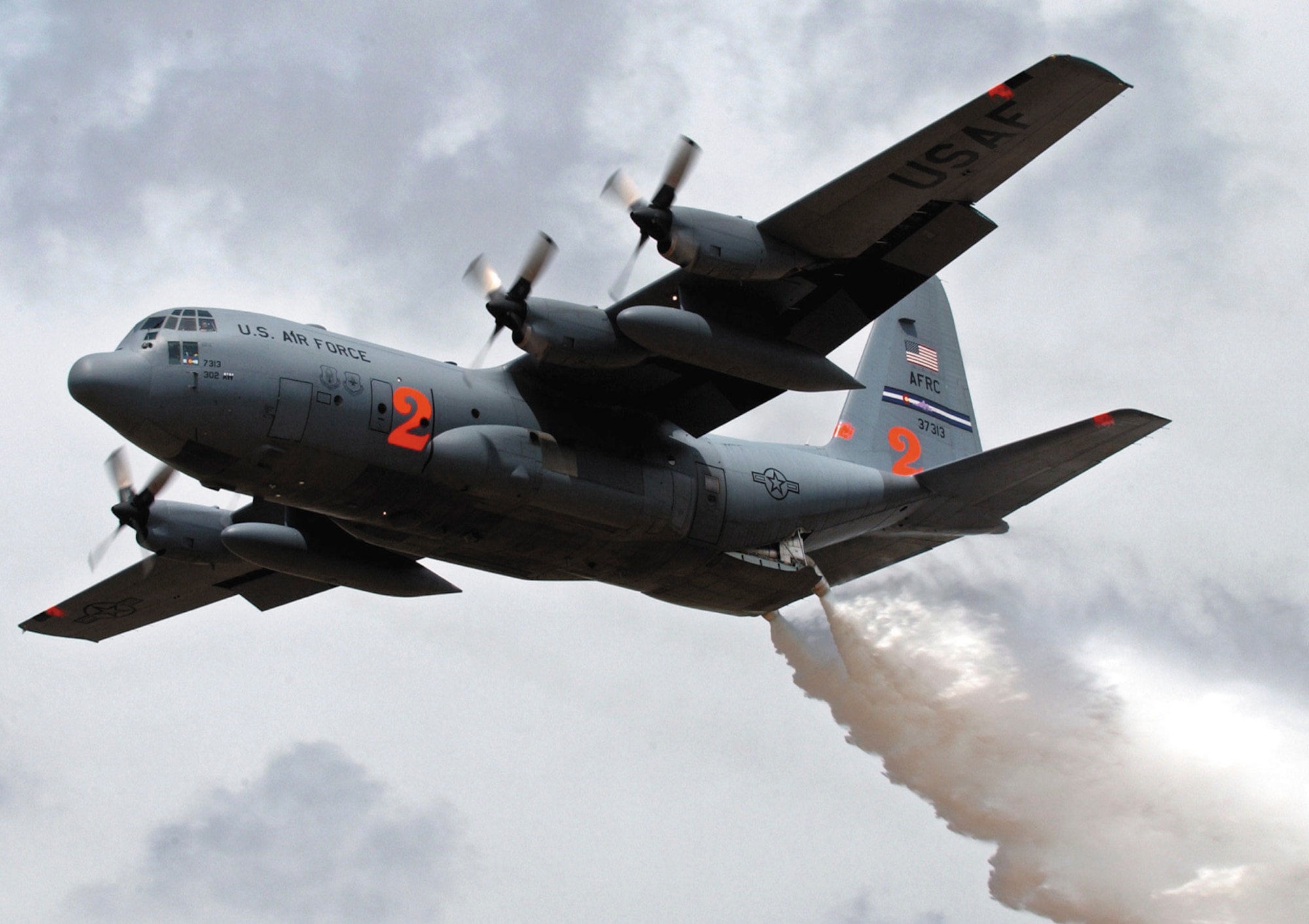 A C-130H Hercules from the 302nd Airlift Wing at Peterson Air Force Base, Colo., drops a load of water during annual Modular Airborne Firefighting System training in Albuquerque, N.M., May 2. C-130 aircrews from the 302nd and three Air National Guard units participated in the training in preparation for the 2007 wild fire season. The 302nd AW is the only Air Force Reserve Command unit equipped with the airborne firefighting system. In an actual mission, a C-130 equipped with MAFFS is capable of dropping 2,700 gallons of fire-retardant chemicals. Crews drop the chemicals in front of, not directly on, fires in an effort to slow down or stop their progress. (Tech. Sgt. Rick Sforza)  
