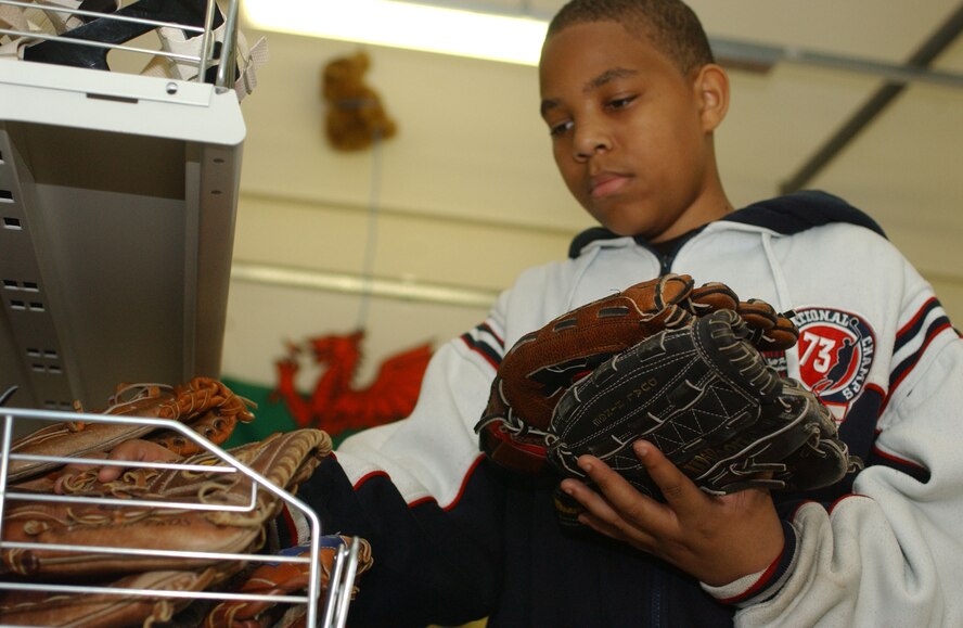 Darrell Hampton, 14, checks out the baseball gloves available for rent at the RAF Mildenhall Outdoor Recreation Center July 11. The center carries many types of sporting equipment including footballs, baseballs, bicycles and canoes. (U.S. Air Force photo by Airman Brad Smith)                             