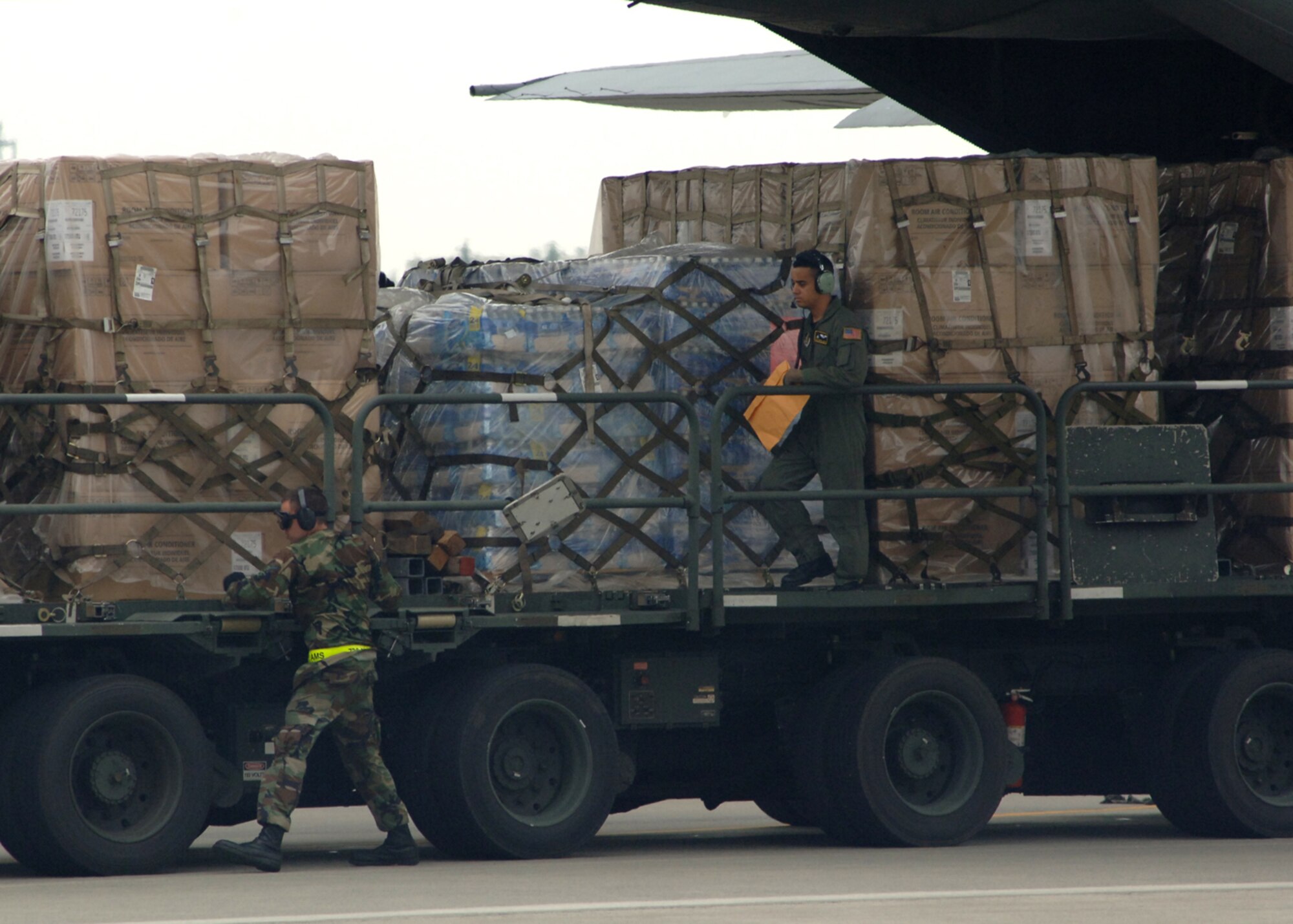 Airmen from the 374th Airlift Wing load supplies on to a C-130 Hercules for shipment to Niigata Airport on July 18. The 374 AW provided 10,000 pounds of water and 100 air conditioning units to the Government of Japan after an earthquake hit one of Japans largest city on the Sea of Japan. 
(U.S. Air Force photo by Senior Airman Veronica Pierce)