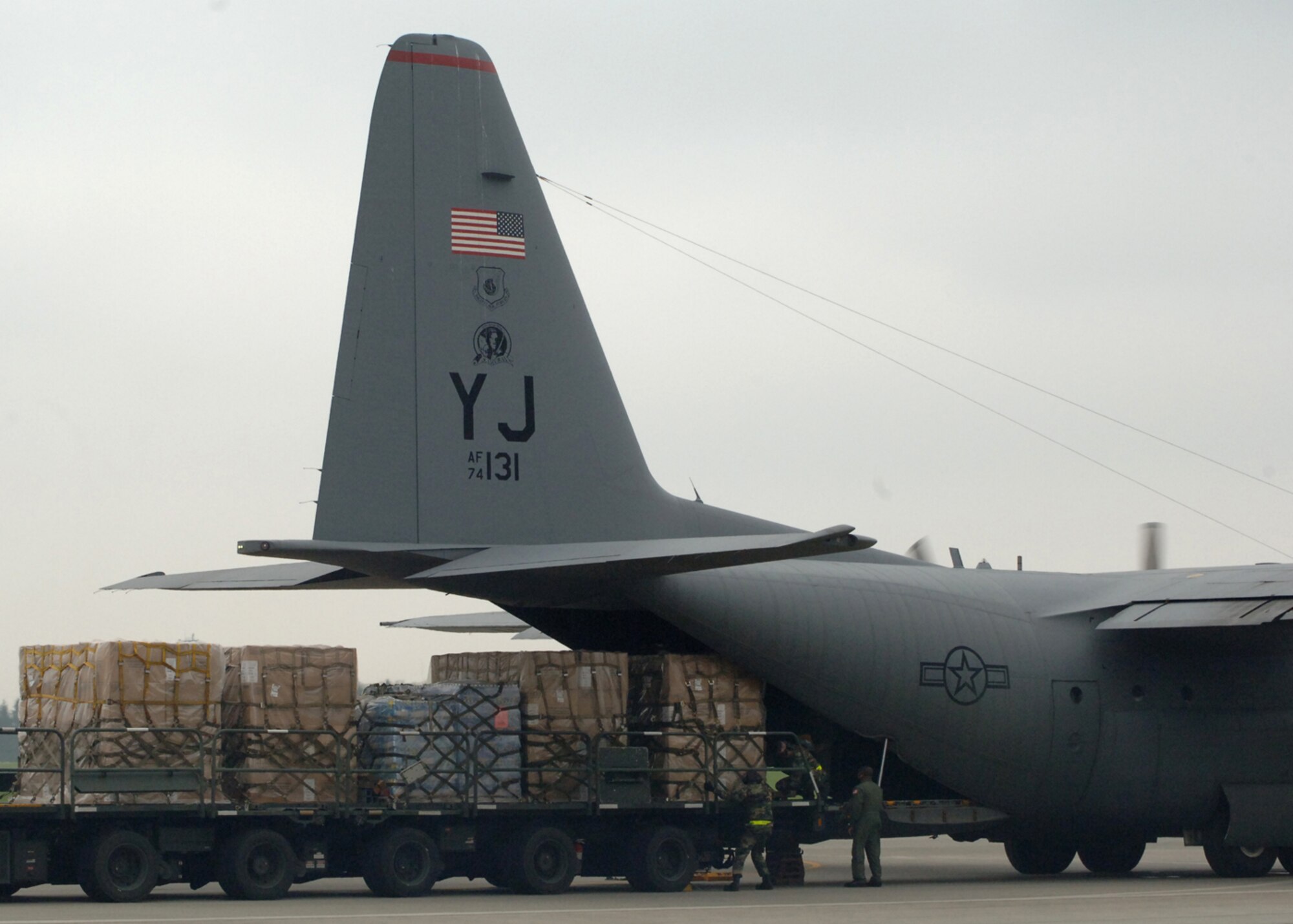 Airmen from the 374th Airlift Wing load supplies on to a C-130 Hercules for shipment to Niigata Airport on July 18. The 374 AW provided 10,000 pounds of water and 100 air conditioning units to the Government of Japan after an earthquake hit one of Japans largest city on the Sea of Japan. 
(U.S. Air Force photo by Senior Airman Veronica Pierce)