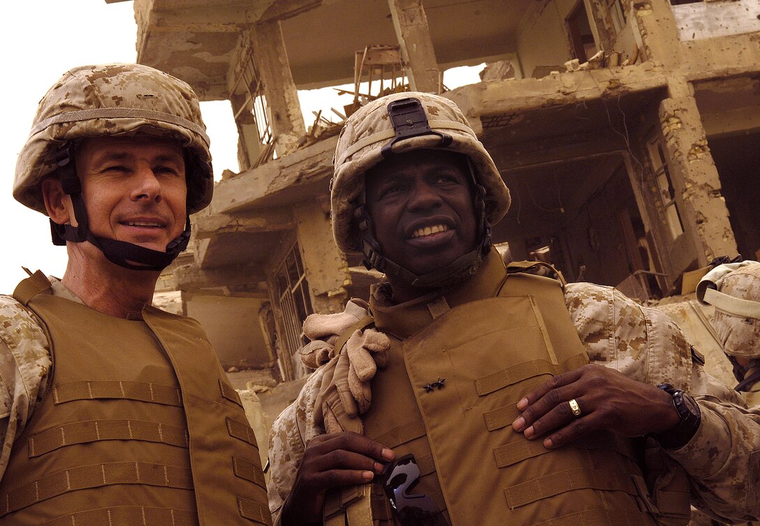 Chairman of the Joint Chiefs of Staff U.S. Marine Gen. Peter Pace and Maj. Gen. Walter Gaskin, commander of Multinational Force West, scan the city of Ramadi, Iraq, July 17, 2007.