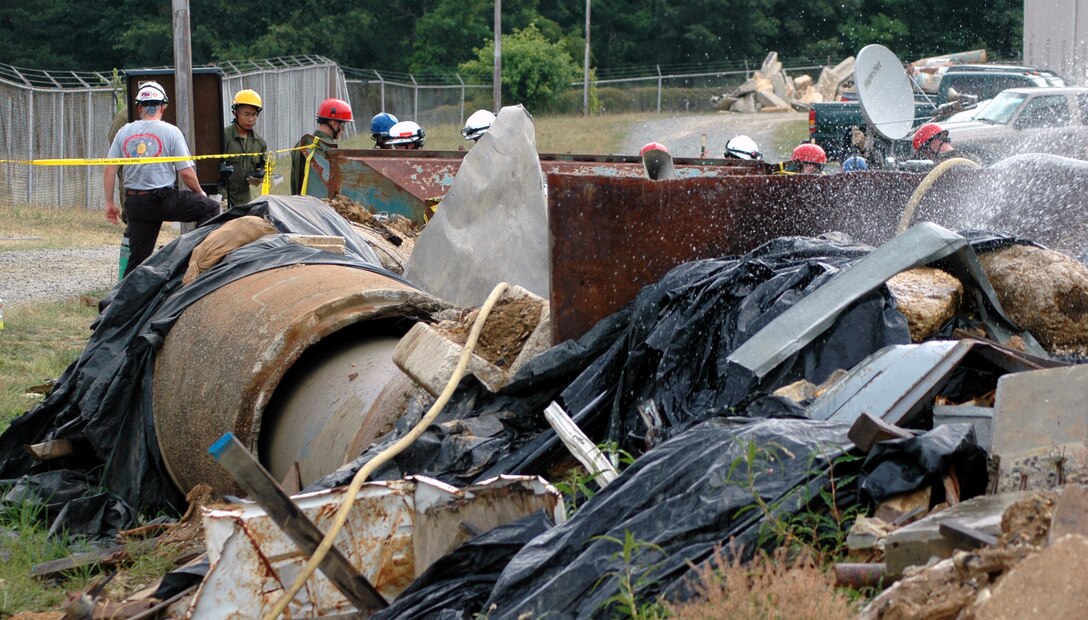 STUMP NECK NAVY ANNEX, INDIAN HEAD, Md. ? Marines of Chemical Biological Incident Response Force, II Marine Expeditionary Force, prepare to enter the collapsed-structure trainer and extract simulated casualties during a CBIRF Basic Course here July 19. The CBC training required the Marines to team up in pairs and search the structure for simulated victims.