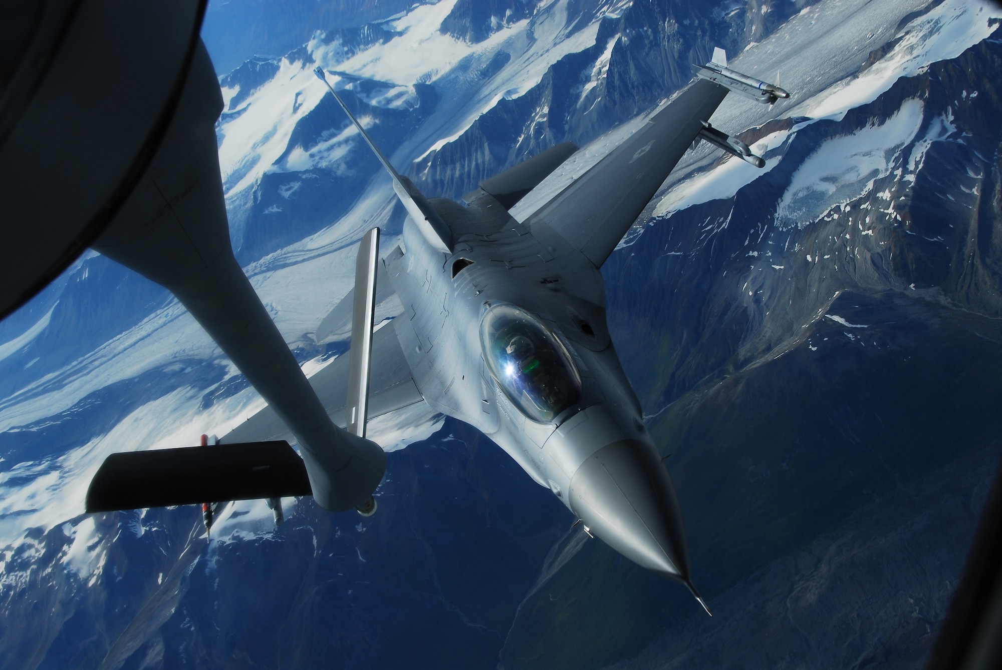EIELSON AIR FORCE BASE, Alaska -- An F-16, 18th Fighter Squadron, Eielson AFB, sits in precontact position behind a KC-135R Stratostanker, 91st Air Refueling Squadron, Macdill AFB, over the Pacific Alaskan Range Complex on July 19 during Red Flag-Alaska 07-3. The KC-135R is flying at 20,000ft and providing 45,000lb of fuel to ten different aggressor aircraft. (U.S. Air Force Photo by Airman 1st Class Jonathan Snyder)