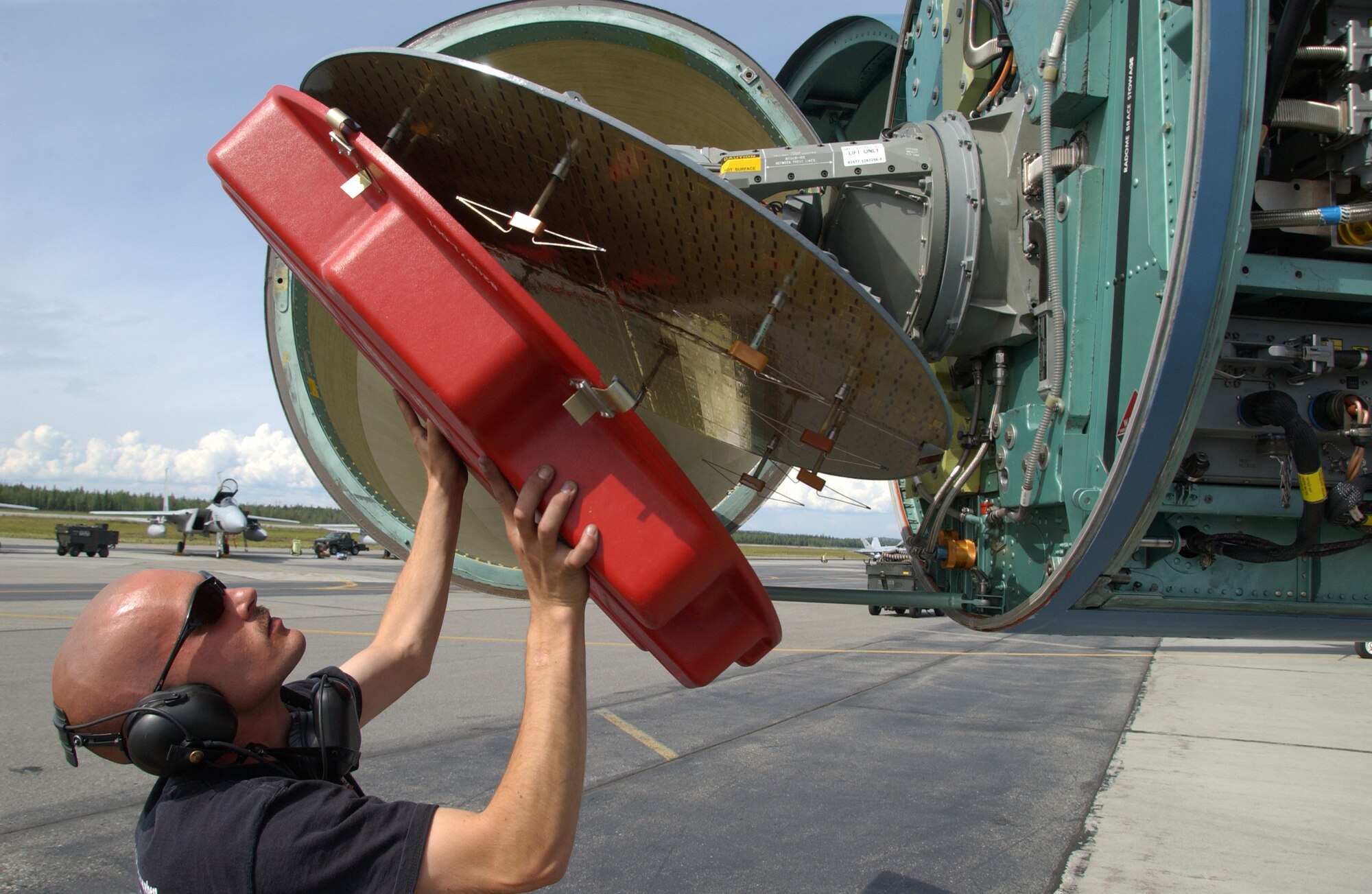EIELSON AIR FORCE BASE, Alaska -- Senior Airman Joseph Matulka, 57th Aircraft Maintenance Squadron, Nellis Air Force Base, Nev., removes a cover from the front of a F-15 to check for a leak July 19, 2007. Red Flag-Alaska provides training for deployed maintenance and support personnel in sustainment of a large-force deployed air operation. (U.S. Air Force photo by Airman 1st Class Christopher Griffin)