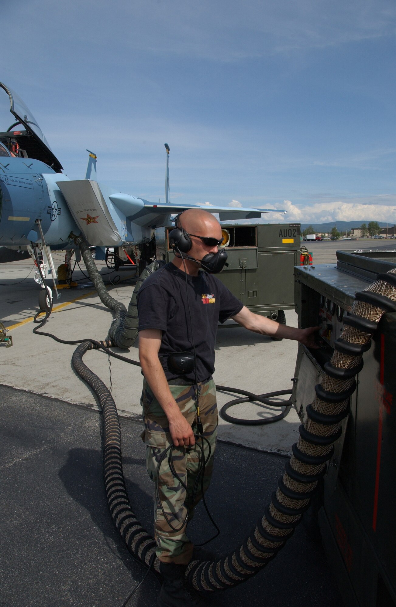 EIELSON AIR FORCE BASE, Alaska -- Senior Airman Joseph Matulka, 57th Aircraft Maintenance Squadron, Nellis Air Force Base, Nev., turns on an air compressor in the process of trying to find a leaking hose on a F-15 July 19, 2007. Red Flag-Alaska provides training for deployed maintenance and support personnel in sustainment of a large-force deployed air operation. (U.S. Air Force photo by Airman 1st Class Christopher Griffin)