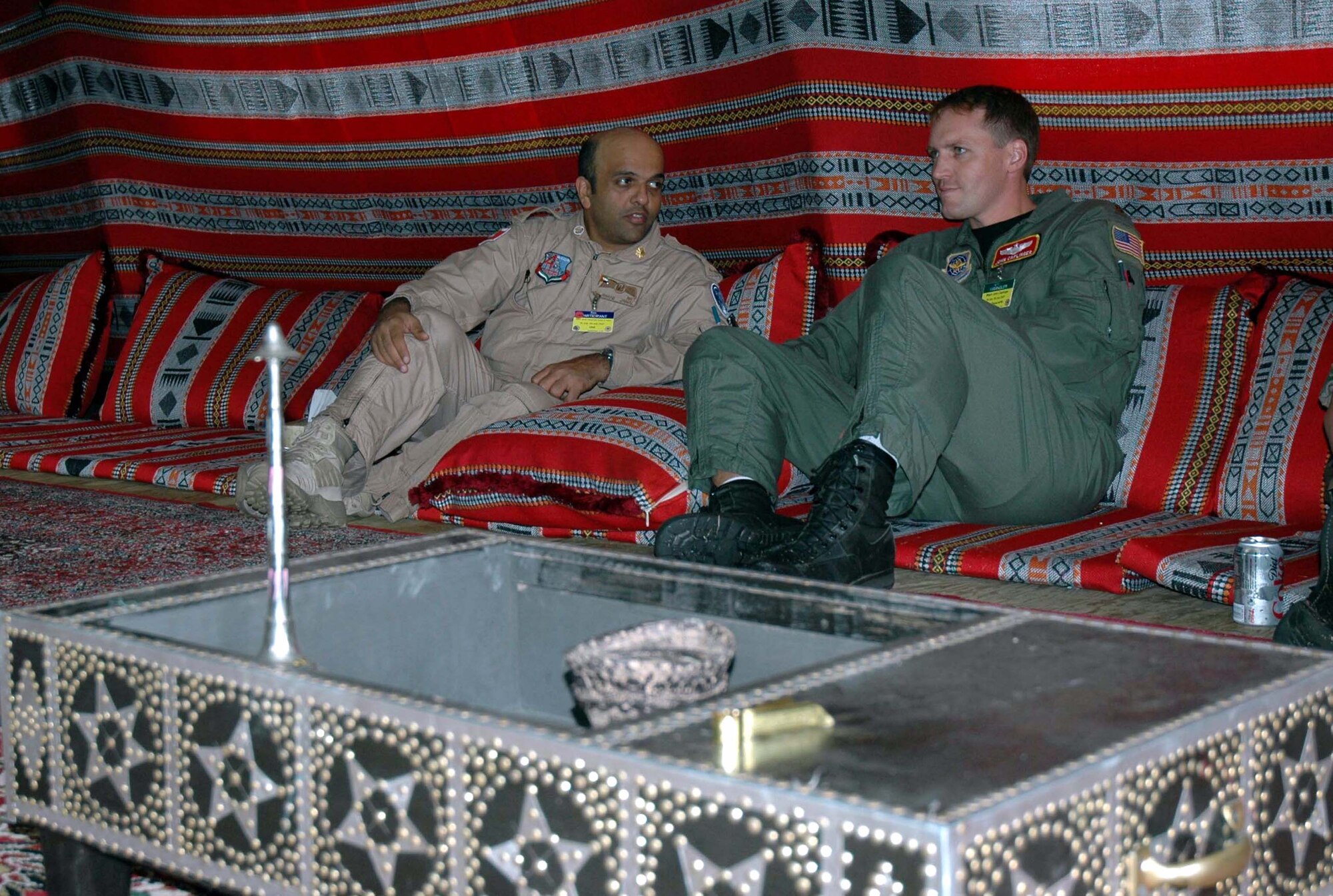Maj. Jamal Al Awani, commander of the United Arab Emirates Air Mobility Rodeo 2007 team, talks with Maj. John Caplinger, a pilot from the 10th Airlift Squadron, at the UAE tent in "Rainier Ranch" at McChord Air Force Base, Wash., July 20. The UAE team is competing in their first Rodeo competition. Rodeo is a readiness competition for U.S. and international mobility air forces.  The competition is sponsored by Air Mobility Command.  (U.S. Air Force photo/Staff Sgt. Nick Przybyciel)