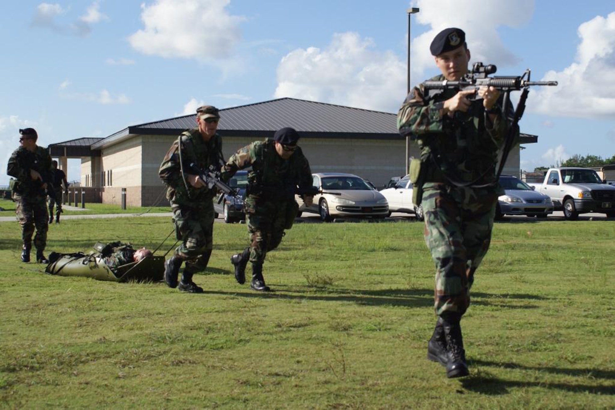 Senior Airman Frank Betancourt (right) provides cover as members of the 482nd Security Forces practice evacuating a wounded Airmen from a hostile-fire zone during training here July 18. Airmen from the 482nd Security Forces and Medical Squadrons joined members of Special Operations Command South for critical training in the Combat Lifesaver Course. Participants learned advanced first-aid techniques and how to stabilize wounded troops before evacuating them. (U.S. Air Force photo/Dan Galindo)