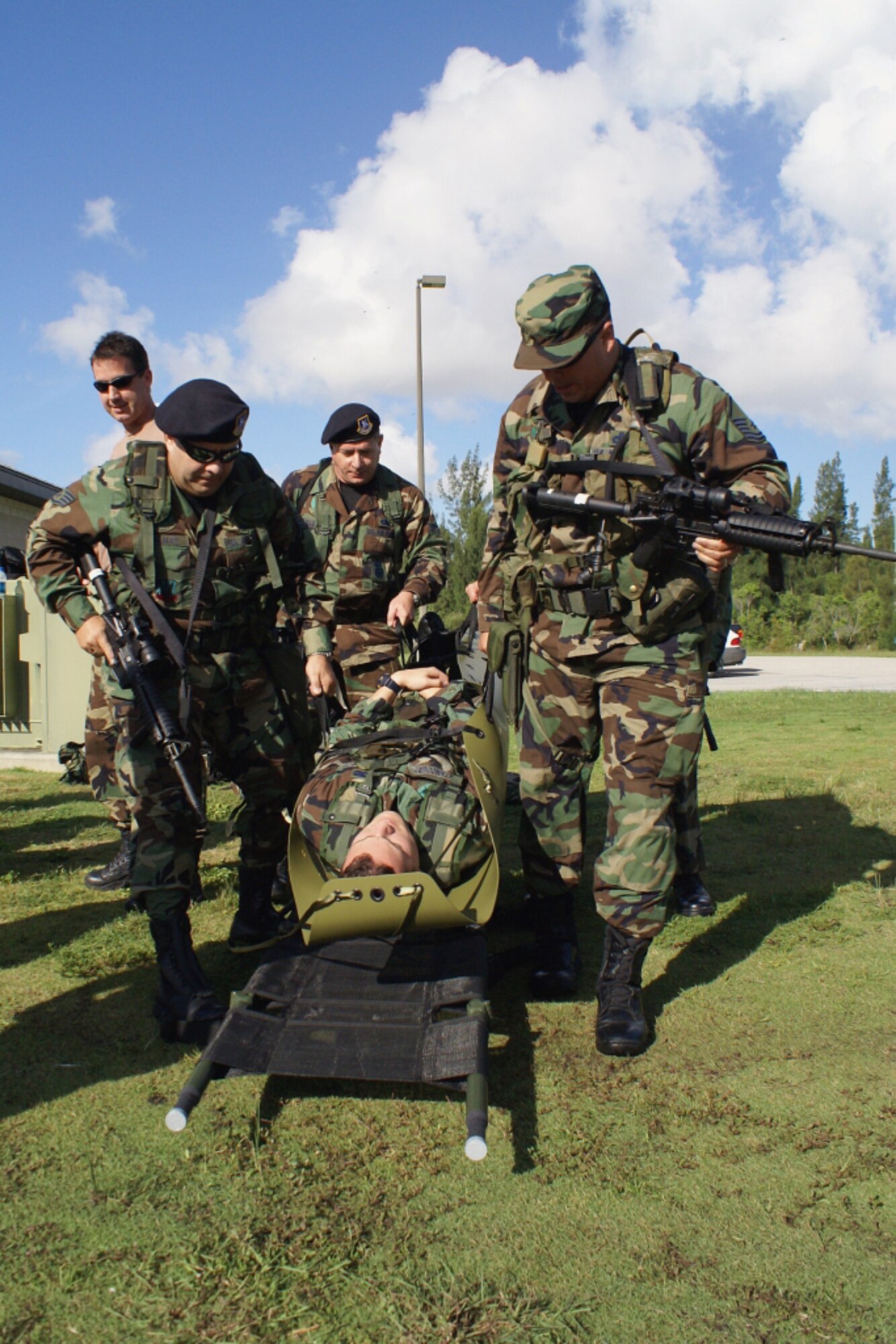 Master Sgt. John Frank (right), Staff Sgt. Ranier Gonzalez (left) and Senior Airman George Allender practice transporting a patient during training here July 18. Airmen from the 482nd Security Forces and Medical Squadrons joined members of Special Operations Command South for critical training in the Combat Lifesaver Course. In addition to advanced first-aid techniques, participants learned how to assemble a litter-hoist for extraction of patients by helicopter from a hostile-fire zone. (U.S. Air Force photo/Dan Galindo)
