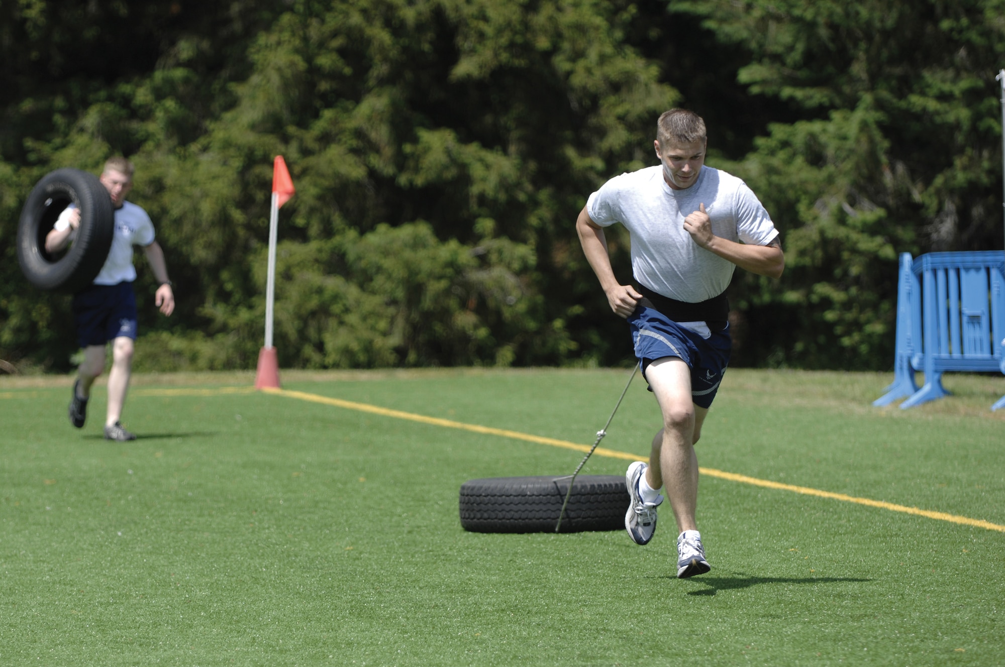 Senior Airman Thomas Grover, 62nd Maintenance Group Rodeo team, pulls a tire as he works to improve his running speed for Rodeo.  The weekly 62nd MXG fitness routine consisted of a cardio workout, two days in the gym and three days of circuit training. (Photo by Abner Guzman)
