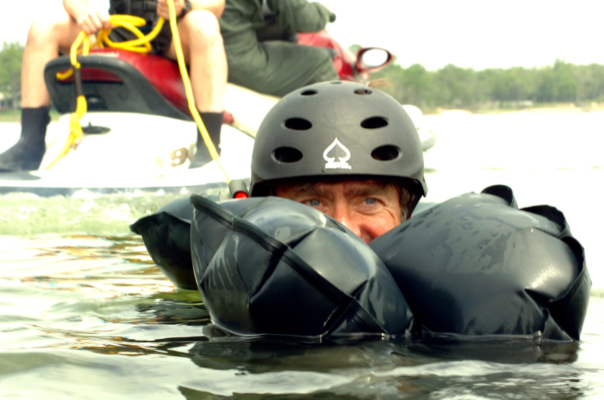 EGLIN AIR FORCE BASE, Fla. -- Richard McNeese, honorary commander for the 33d Fighter Wing's 33d Operations Support Squadron, peers over his life preserver unit July 20, preparing for a simulated parachute drag on Eglin Air Force Base. The simulation was part of Survivor Skills Day, during which honorary commanders learned land and water survival tactics wing pilots are trained to use in emergency situations. Honorary commanders are civic leaders paired with wing leadership for a year-long immersion in the mission, with a goal of educating the civilians about the Air Force and its people. Honorary commanders from the 53d Wing also participated. (U.S. Air Force photo by Staff Sgt. Bryan Franks)

