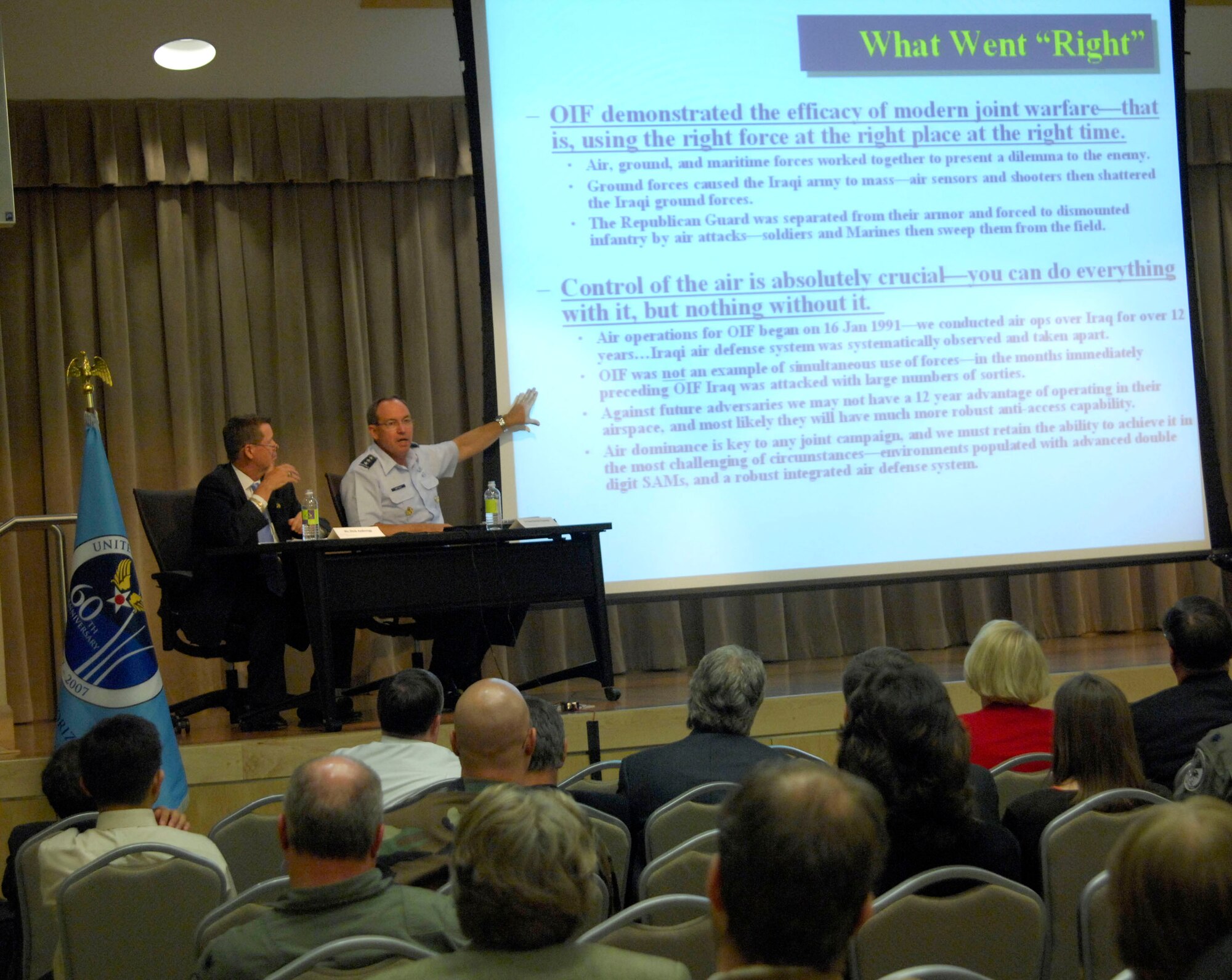 Lt. Gen. David Deptula (right), Air Force deputy chief of staff for intelligence, briefs on progress in Iraq July 19 during the third of three "Living Legends" seminars held at the Pentagon Conference Center in Arlington, Va.  The panel for this seminar included Dick Anderegg (on left), director of Air Force history and museums policies and programs, as well as two retired senior officers, Lt. Gen. John Campbell and Maj. Gen. Charles Link, who added their insight on Iraq. (U.S. Air Force photo/Tech. Sgt. Cohen A. Young)