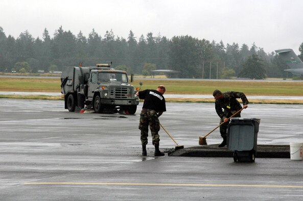 Airmen working as "Wranglers" for Air Mobility Rodeo 2007 work on cleaning near a hangar for competition ceremonies July 20. Air Mobility Command's Rodeo is a readiness competition of U.S. and international mobility air forces.  It focuses on improving warfighting capabilities and support of the Global War on Terrorism.  (U.S. Air Force Photo/Tech. Sgt. Scott T. Sturkol)