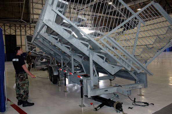 An Airman working as a "Wrangler" for Air Mobility Rodeo 2007 works on setting up bleachers in a hangar for competition ceremonies July. Air Mobility Command's Rodeo is a readiness competition of U.S. and international mobility air forces.  It focuses on improving warfighting capabilities and support of the Global War on Terrorism.  (U.S. Air Force Photo/Tech. Sgt. Scott T. Sturkol)