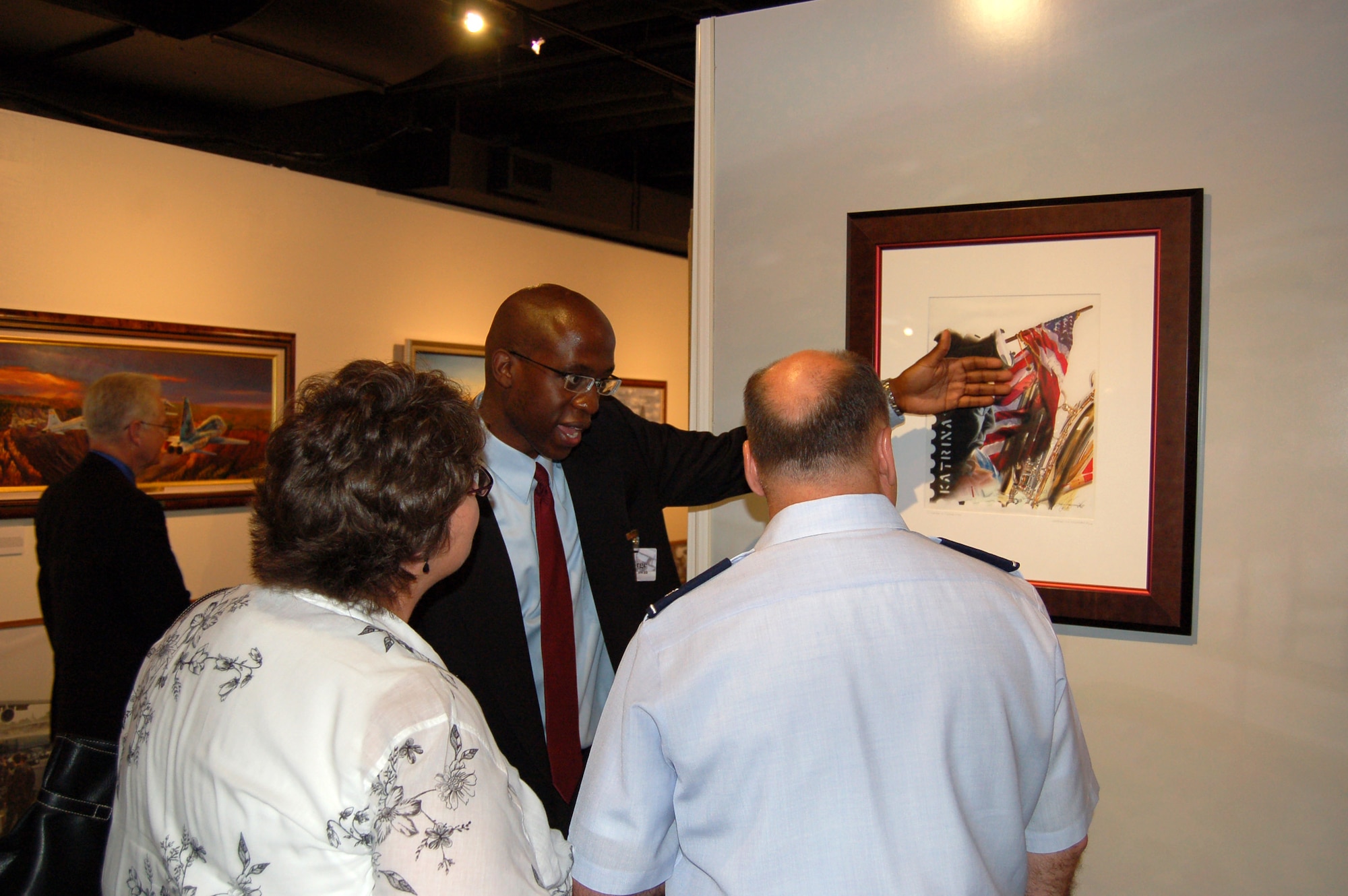 George McCowan explains some of the details of his work titled "A Lesson of Desperation," which covers the Hurricane Katrina relief effort through a collage of images. Mr. McCowan is an Air Force Art Program artist member. (U.S. Air Force photo/Staff Sgt. Shad Eidson) 
