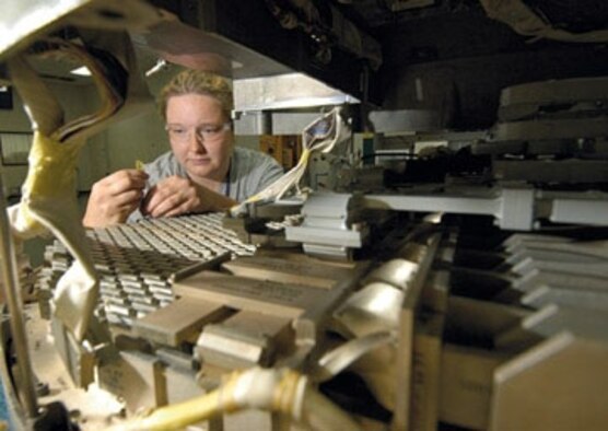 Electronics technician Janae Starkey re-assembles a B-1 antenna after testing in Tinker's B-1 Antenna Shop. The shop is the only one in the Air Force working on the bomber's antenna repair. (Air Force photo by Margo Wright)