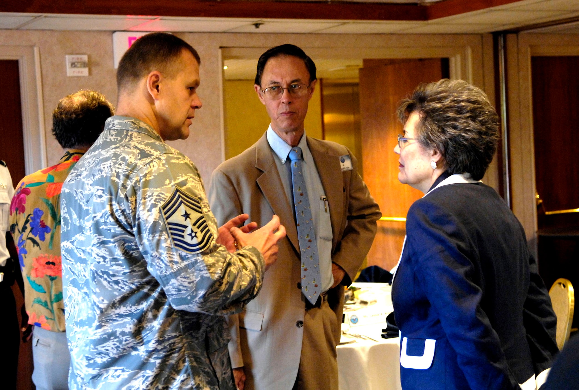 Chief Master Sgt. James Roy talks with Under Secretary of Defense for Personnel and Readiness Dr. David S. C. Chu and Deputy Under Secretary of Defense for Military Community and Family Policy Leslye A. Arsht during a breakfast meeting July 18 at the Hale Koa Hotel in Honolulu. The secretaries are in Hawaii to discuss state and Department of Defense partnership issues. Chief Roy Chief Master Sergeant James A. Roy is the command chief master sergeant for United States Forces Japan and 5th Air Force. (U.S. Air Force photo/Tech. Sgt. Shane A. Cuomo) 
