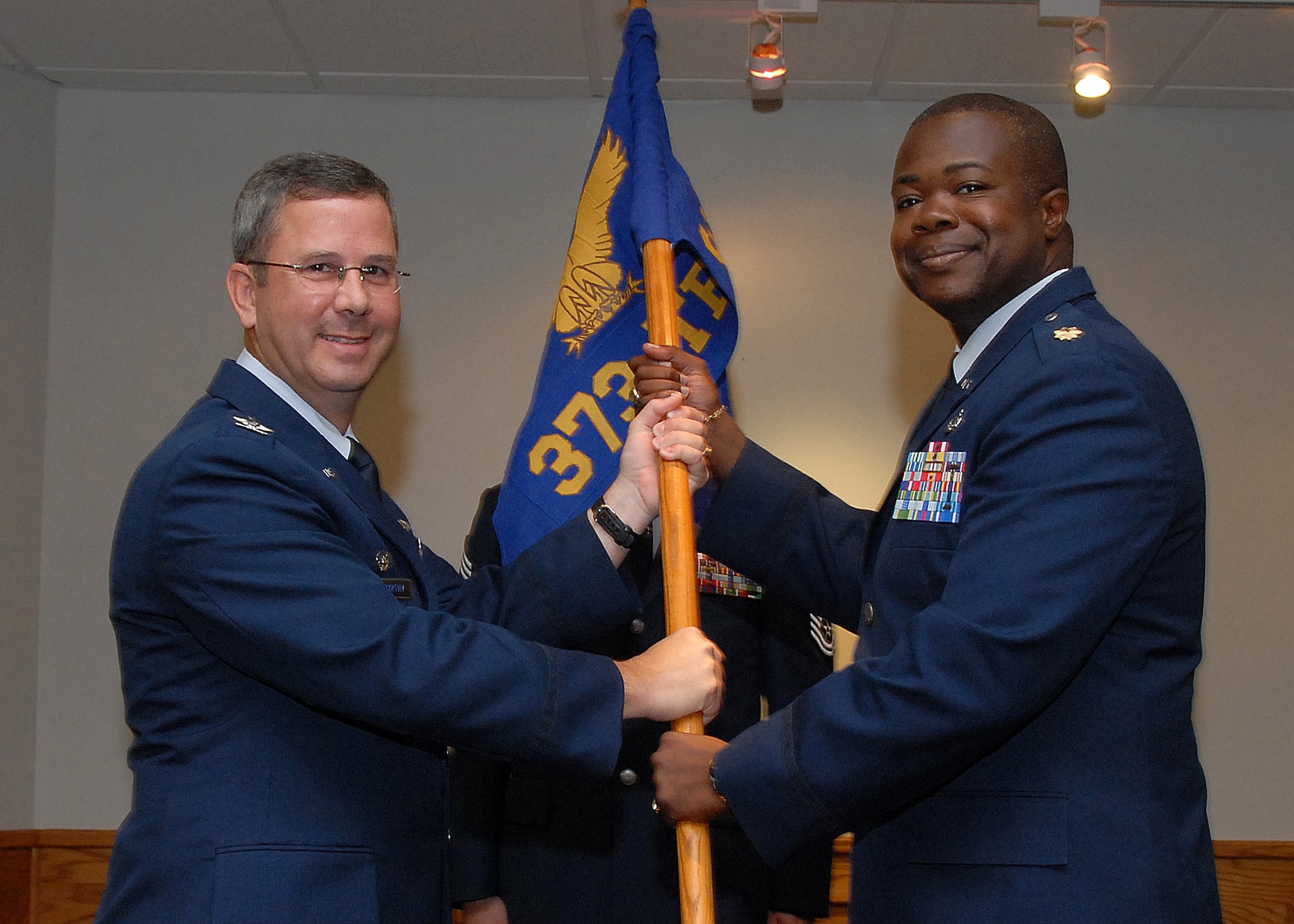 Col. David Norsworthy, 982nd Training Group commander, presents the guidon to new 373rd Training Squadron commander Maj. Henry Myers Jr. at the 373rd TRS's change-of-command ceremony July 19. (U.S. Air Force photo/Mike Litteken)