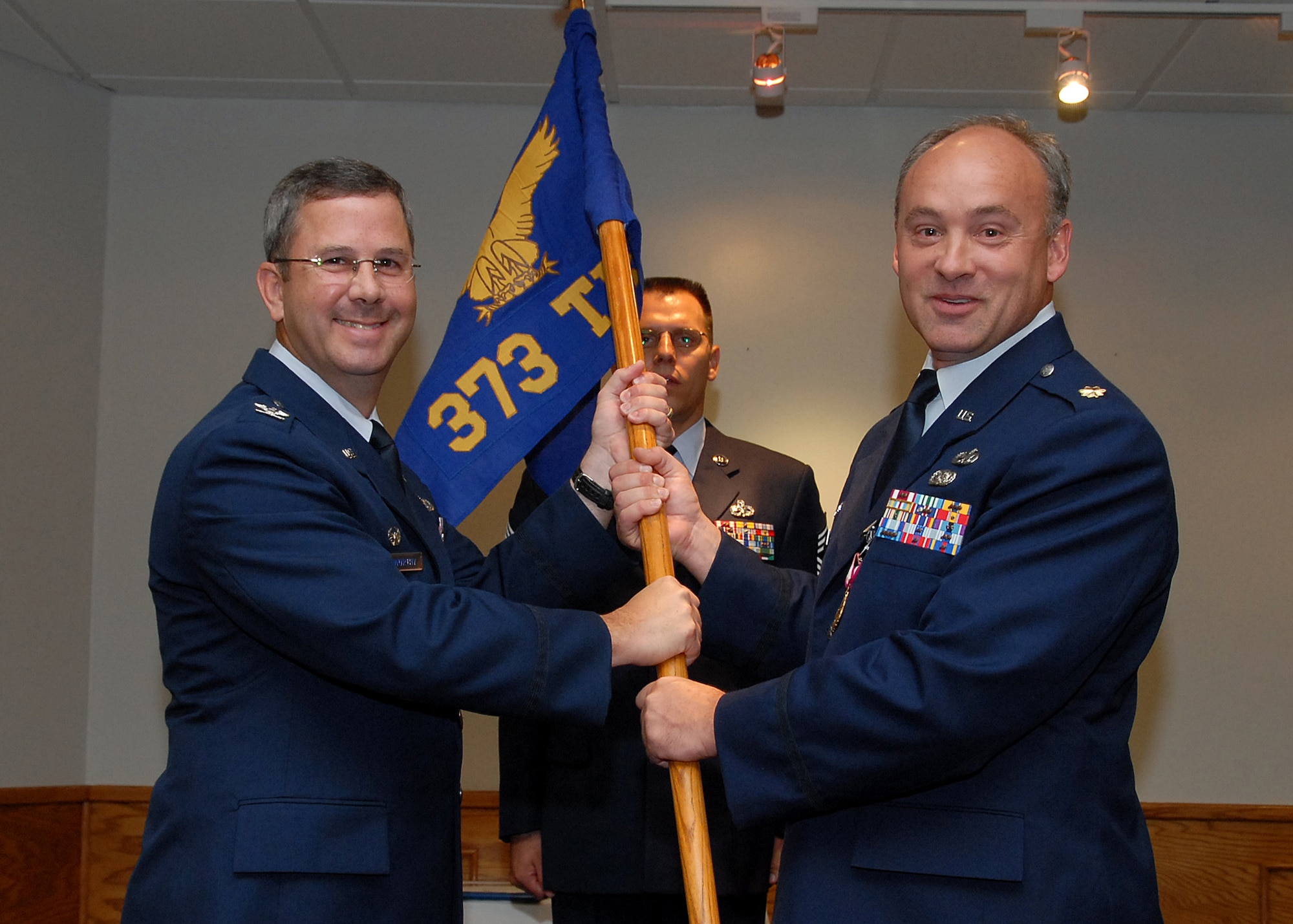 Col. David Norsworthy, 982nd Training Group commander, accepts the guidon from outgoing 373rd Training Squadron commander Maj. Russell Custer at the 373rd TRS's change-of-command ceremony July 19. (U.S. Air Force photo/Mike Litteken)