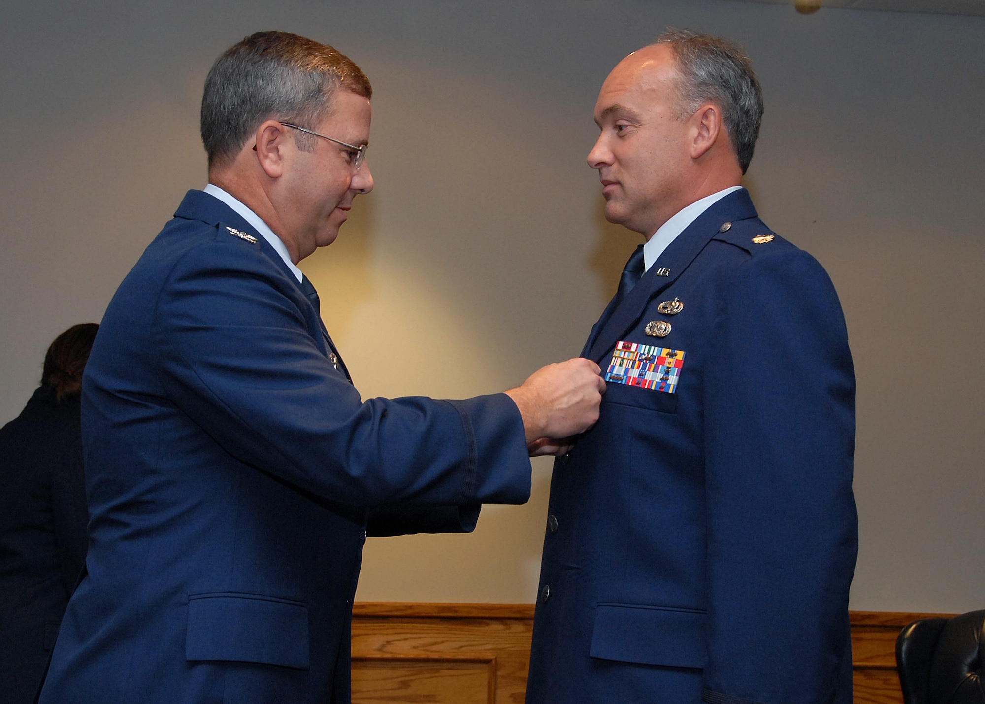 Col. David Norsworthy, 982nd Training Group commander, presents Maj. Russell Custer, outgoing  373rd Training Squadron commander, the Meritorious Service Medal at the 373rd TRS's change-of-command ceremony July 19. (U.S. Air Force photo/Mike Litteken)