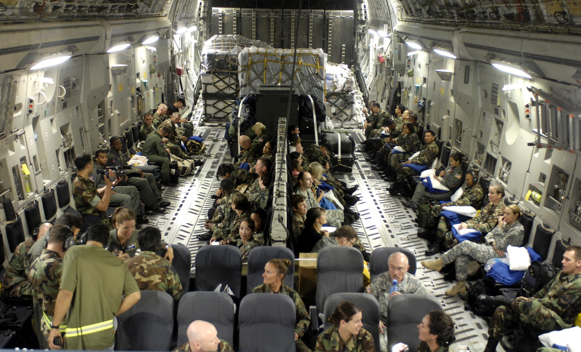HICKAM AIR FORCE BASE, Hawaii -- Medical personnel wait to depart for a humanitarian mission on a C-17 Globemaster III here July 20. Approximately 50 Air Force, Army and Navy personnel traveling to Vanuatu, Kiribati and Nauru to provide medical, dental and engineering support to the local residents. (U.S. Air Force photo/Tech. Sgt. Shane A. Cuomo)