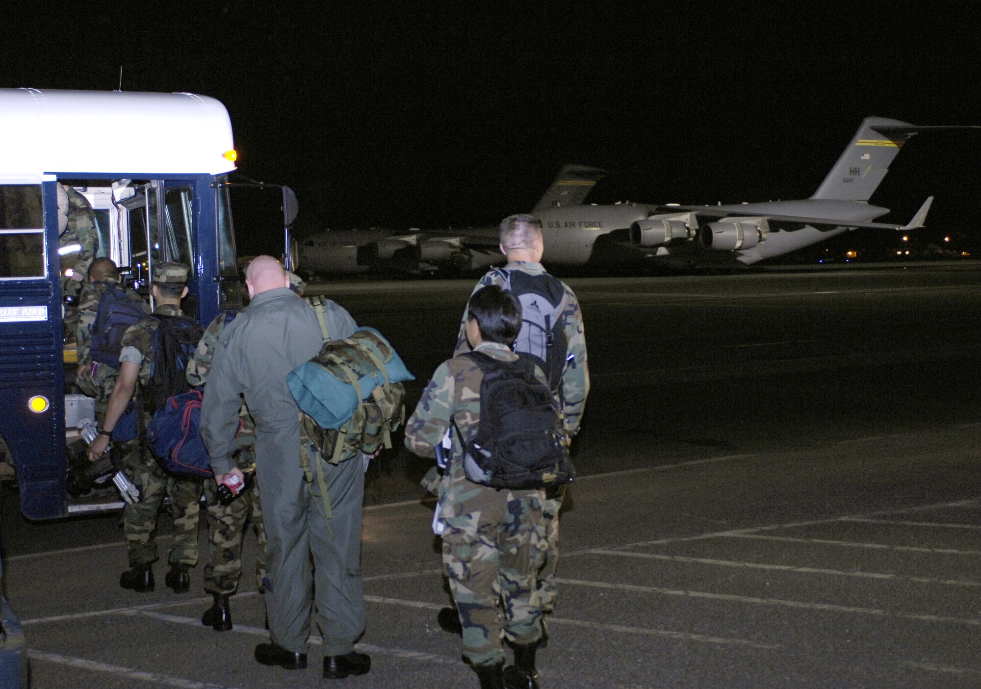 HICKAM AIR FORCE BASE, Hawaii -- Medical personnel board a bus here prior to their departure for a humanitarian mission July 20. Approximately 50 Air Force, Army and Navy personnel are traveling to Vanuatu, Kiribati and Nauru to provide medical, dental and engineering support to the local residents. (U.S. Air Force photo/Tech. Sgt. Shane A. Cuomo)