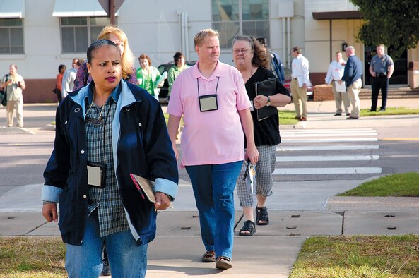 Tinker personnel watch emergency responders as they evacuate Bldg. 1 during a recent exercise. (Air Force photo by Dave Faytinger)