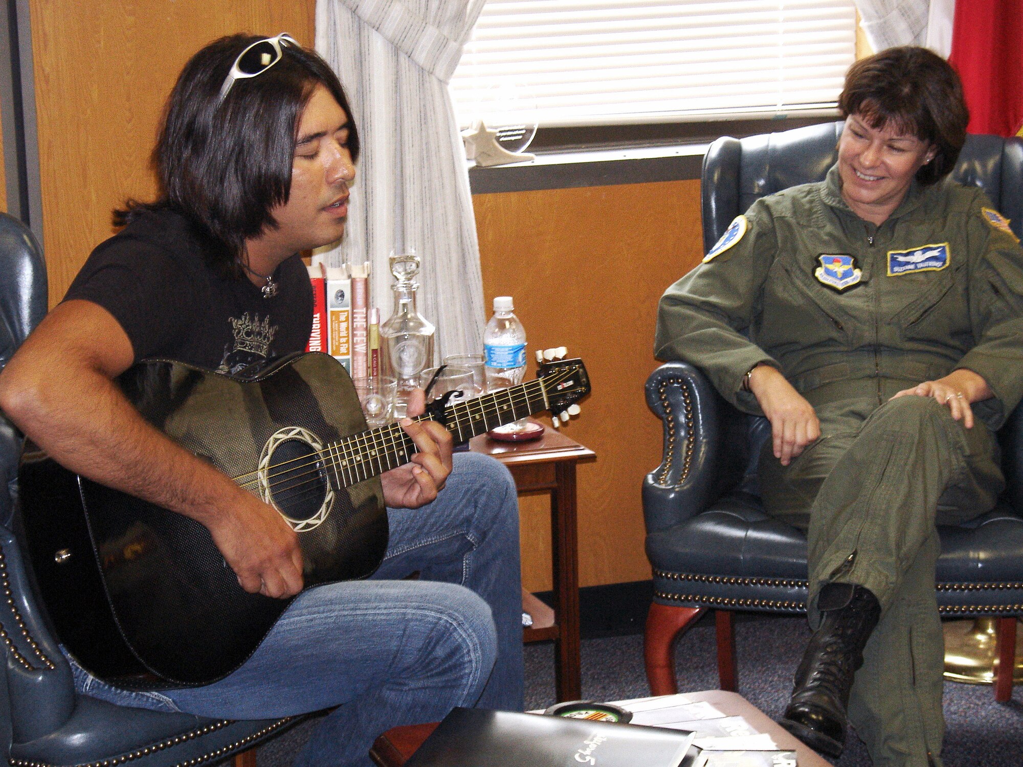 Donovan Chapman performs for Brig. Gen. Suzanne Vautrinot and her staff during a July 18 visit to Air Force Recruiting Service at Randolph Air Force Base, Texas. General Vautrinot is commander of AFRS. Mr. Chapman is a country music singer and recorded two public service announcements of encouragement to servicemembers. (U.S. Air Force photo/Chet R. DelSignore)