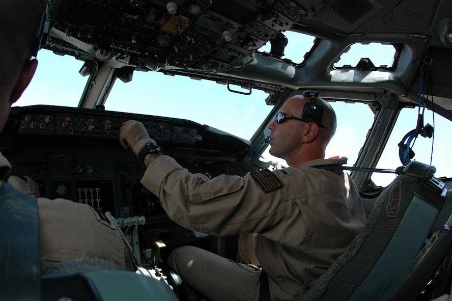 Navy Lt j.g. Nathan Lassas, Task Force 124, enters information into the autopilot computer. Lieutenant Lassas pilots an E-6B Mercury over Iraq which helps Soldiers communicate on the ground. (Photo by Staff Sgt. Cassandra Locke)