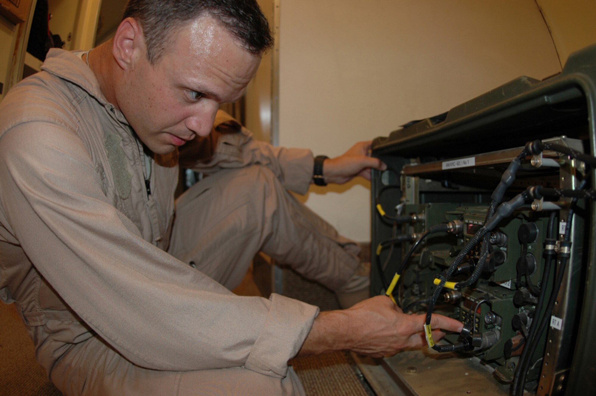 Navy Petty Officer 2nd Class Kasey Bruce, Task Force 124, performs routine maintenance on an E-6B Mercury prior to its flight over Iraq. Petty Officer Bruce is deployed here from Tinker Air Force Base, Okla. (Photo by Senior Airman Clark Staehle)