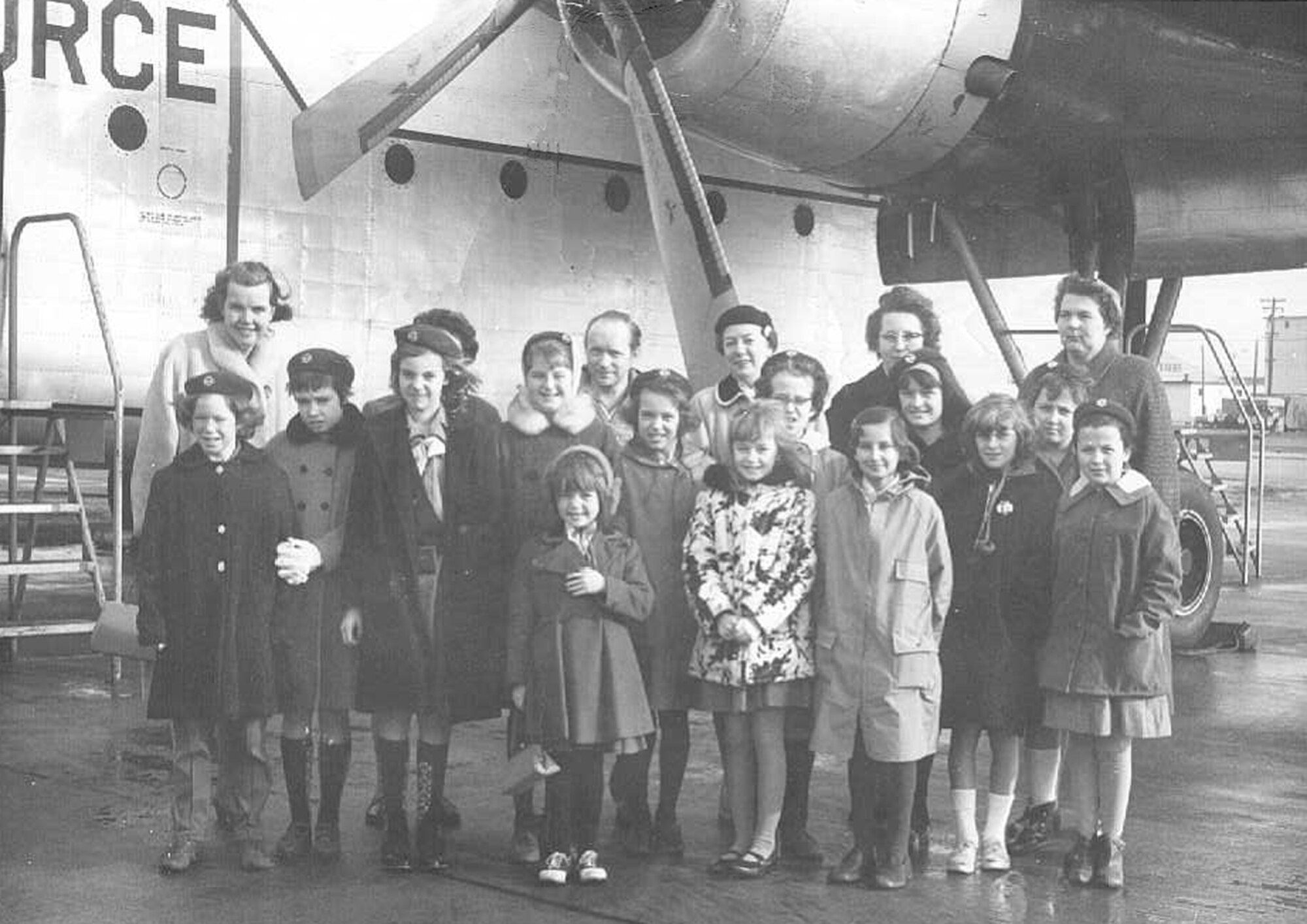 HANSCOM AFB, Mass., -- Chief Master Sgt. Snow’s wife, Catherine, back row, first on left; daughter, Madelyn, front row, third from left; and daughter, Barbara, front row, center, attend a school field trip to Hanscom and pose in front of a C-119. (Courtesy Photo)