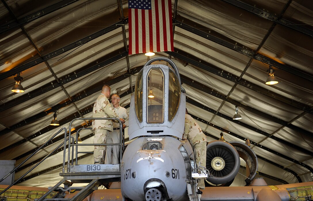 Deputy Secretary of Defense Gordon R. England receives a tour of an A-10 Warthog from Tech. Sgt. Gaylin Taylor and Tech. Sgt. Emery Makany in Bagram, Afghanistan, July 20, 2007.  Taylor and Makany are deployed in support of the 455th Air Expeditionary Wing, 354th Aircraft Maintenance Squadron and are based out of Davis-Monthan Air Force Base, Ariz.