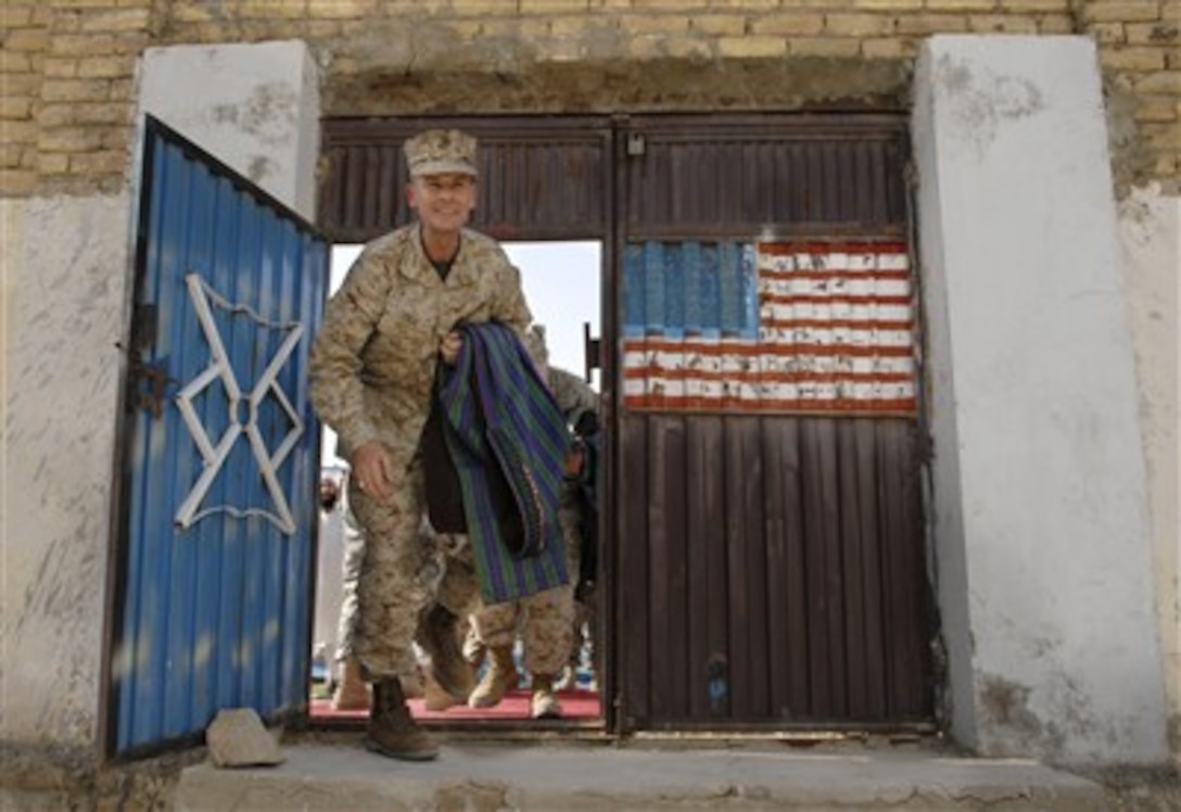 Chairman of the Joint Chiefs of Staff U.S. Marine Gen. Peter Pace leaves a meeting with an Afghanistan governor to meet U.S. soldiers deployed to Qalat, Afghanistan, July 19, 2007.