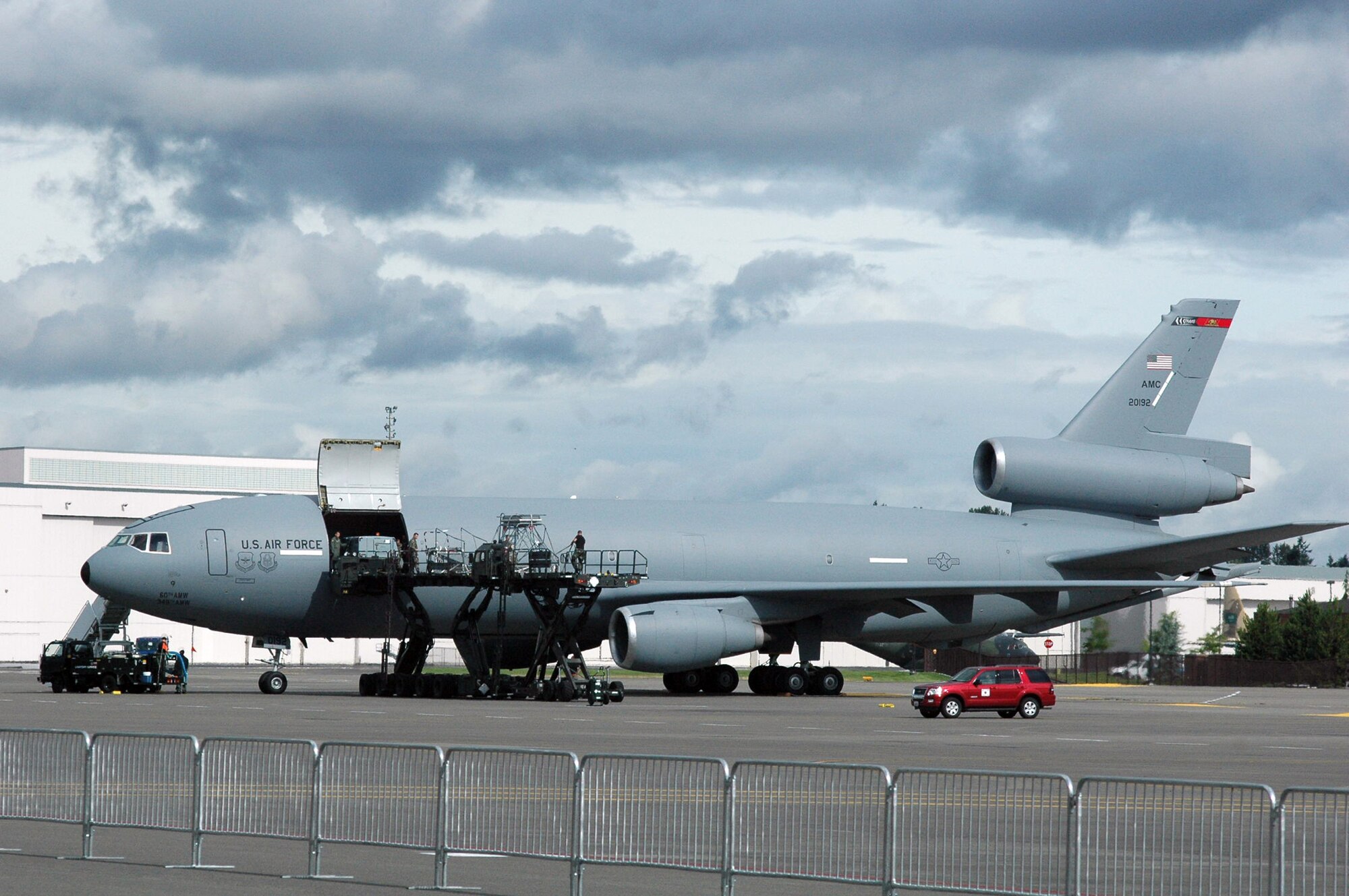 Airmen work to unload a KC-10 Extender from Travis Air Force Base, Calif., after arriving to McChord AFB, Wash., for Air Mobility Rodeo 2007 July 21.  Rodeo, sponsored by Air Mobility Command, is a readiness competition for U.S. and international mobility air forces. This competition focuses on improving world-wide mobility forces' professional core abilities. More than 40 teams and 2,500 people from the Air Force, and Air Force Reserve, as well as allied nations, are expected to participate. (U.S. Air Force Photo/Tech. Sgt. Scott T. Sturkol)