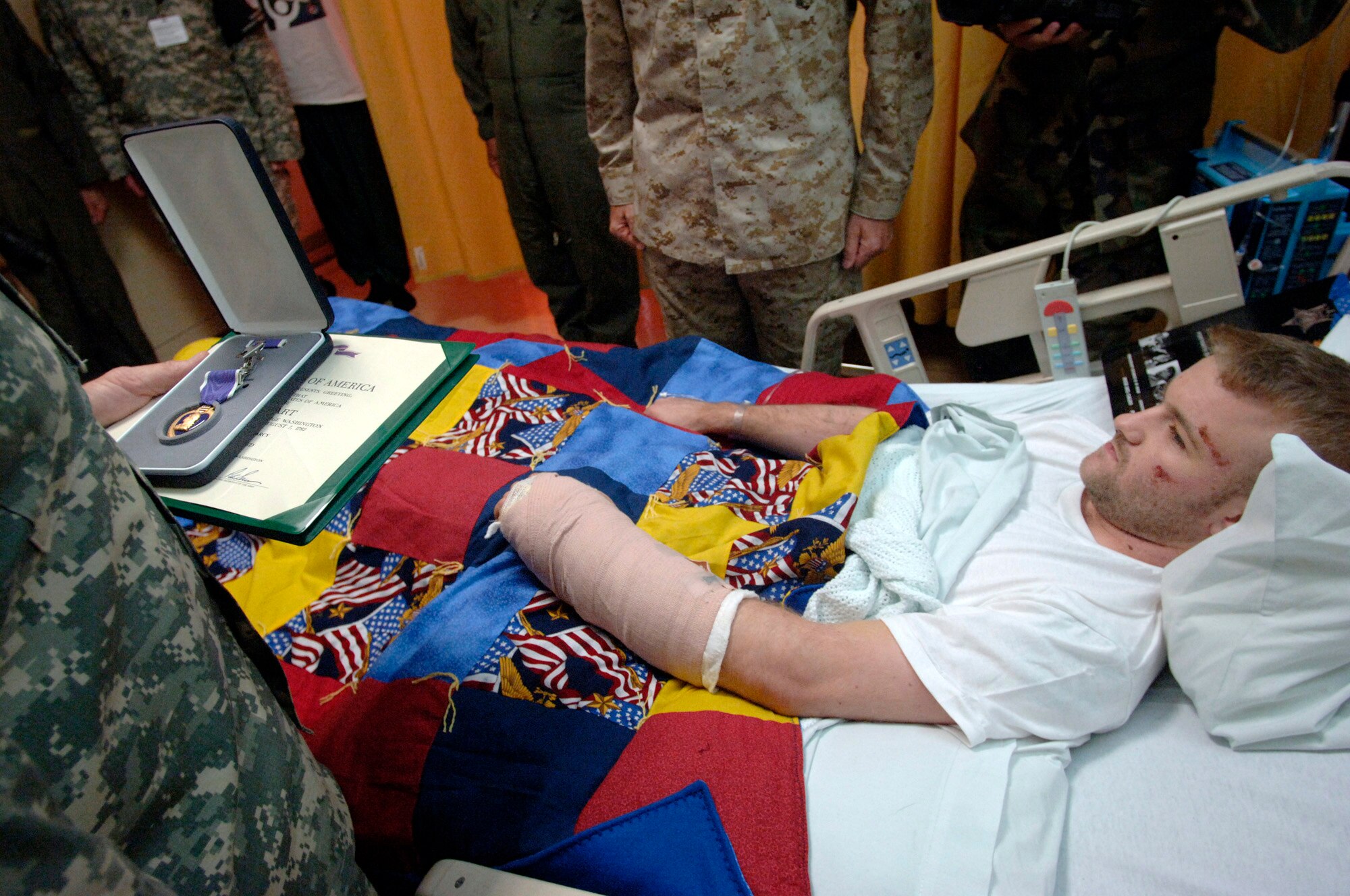 Army Spc. Colin Laird Pearcy receives a Purple Heart medal July 21 from Chairman of the Joint Chiefs of Staff Gen. Peter Pace. Specialist Pearcy sustained injuries in Iraq just four days earlier. (U.S. Air Force photo/Master Sgt. Scott Wagers)
