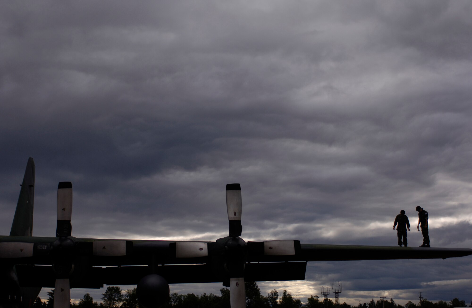 Republic of Korea C-130 crew chiefs inspect the wing of their aircraft as they prepare to launch it for a training mission in preparation for Rodeo 2007 at McChord Air Force Base, July 19. Rodeo 2007, hosted by Air Mobility Command, is a readiness competition of U.S. and international mobility air forces.  It focuses on improving warfighting capabilities and support of the Global War on Terrorism. (U.S. Air Force photo/Tech. Sgt. Adrian Cadiz)

