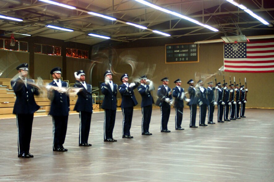 United States Air Force Honor Guard Drill Team  demonstrates their skills at the Skeltal Memorial Fitness Center, Spangdahlem Air Base, Germany.
