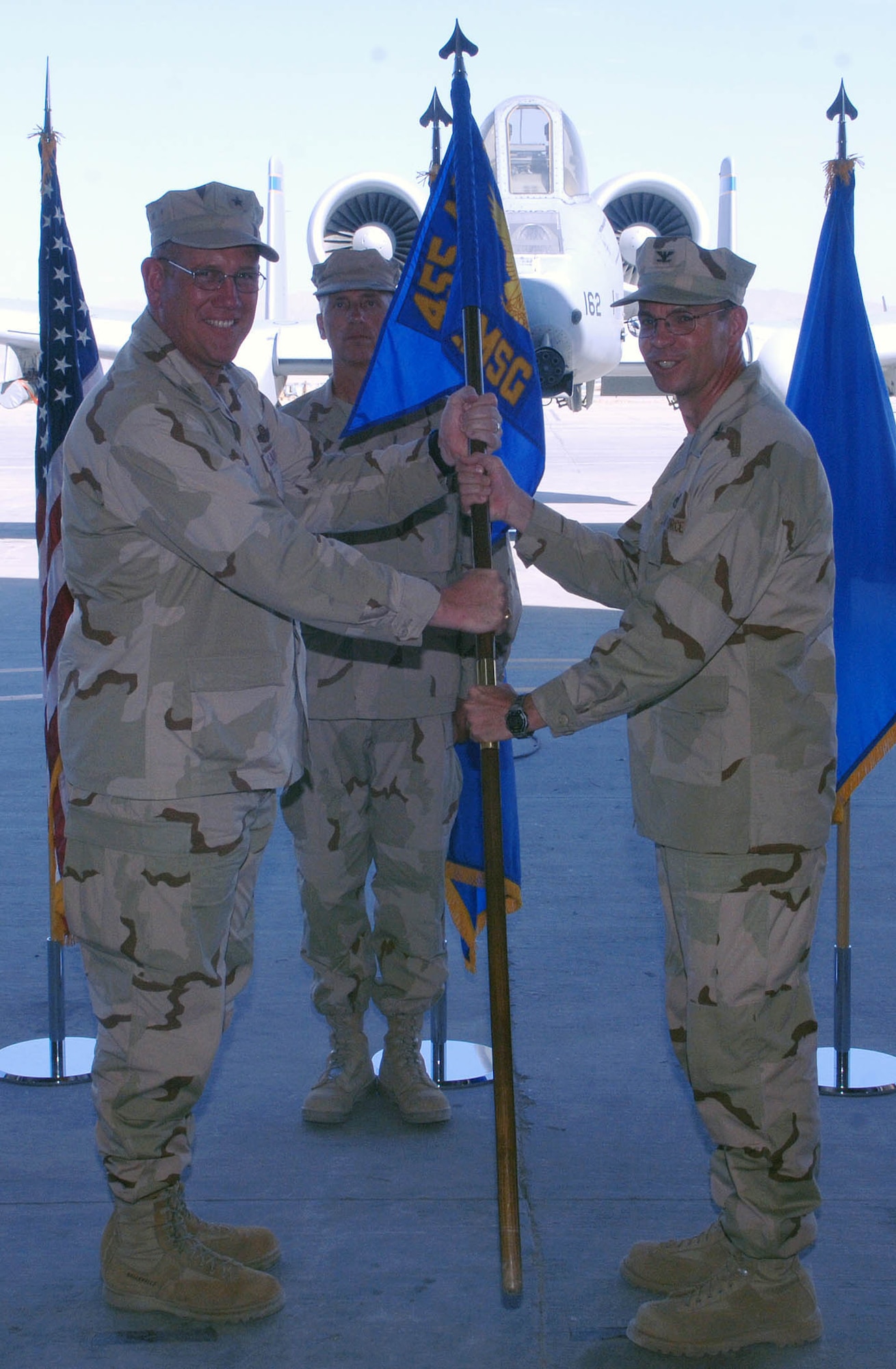 Col. Barry Mines (right), 455th Expeditionary Mission Support Group commander, accepts the group guidon from Brig. Gen. Bill Hyatt, 455th Air Expeditionary Wing commander, signifying the support group's change of command in a ceremony June 18 at Bagram Airfield, Afghanistan. (U.S. Air Force photo by Staff Sgt. Craig Seals)