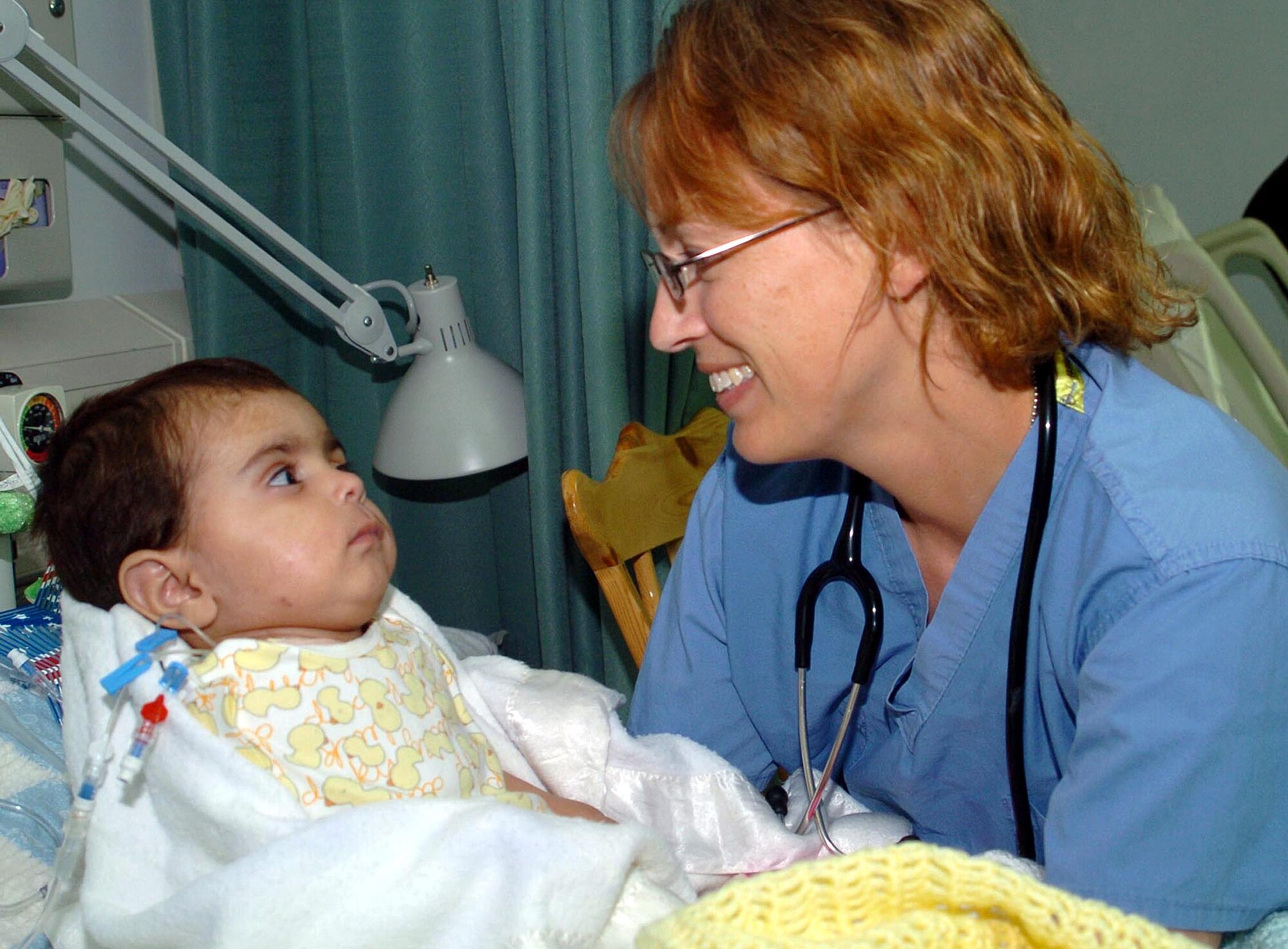 Air Force Dr. (Maj.) Sheralyn Wood, Task Force Med pediatrician deployed from Wilford Hall Medical Center, San Antonio, Texas, checks Salma’s medical progress. Salma is the sole-survivor of an IED explosion that left her severely injured and orphaned. She has been under the care of the Craig Joint-Theater Hospital medical staff at Bagram Airfield, Afghanistan, since July 5. (U.S. Air Force photo by Senior Airman Dilia DeGrego)