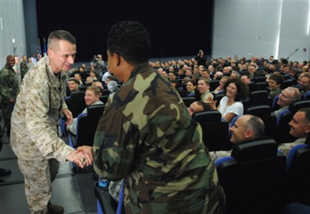 U.S. Marine Corps Gen. Peter Pace, chairman of the Joint Chiefs of Staff, shakes hands with an Air Force technical sergeant at the beginning of the townhall meeting in Stuttgart, Germany, July 20, 2007. 