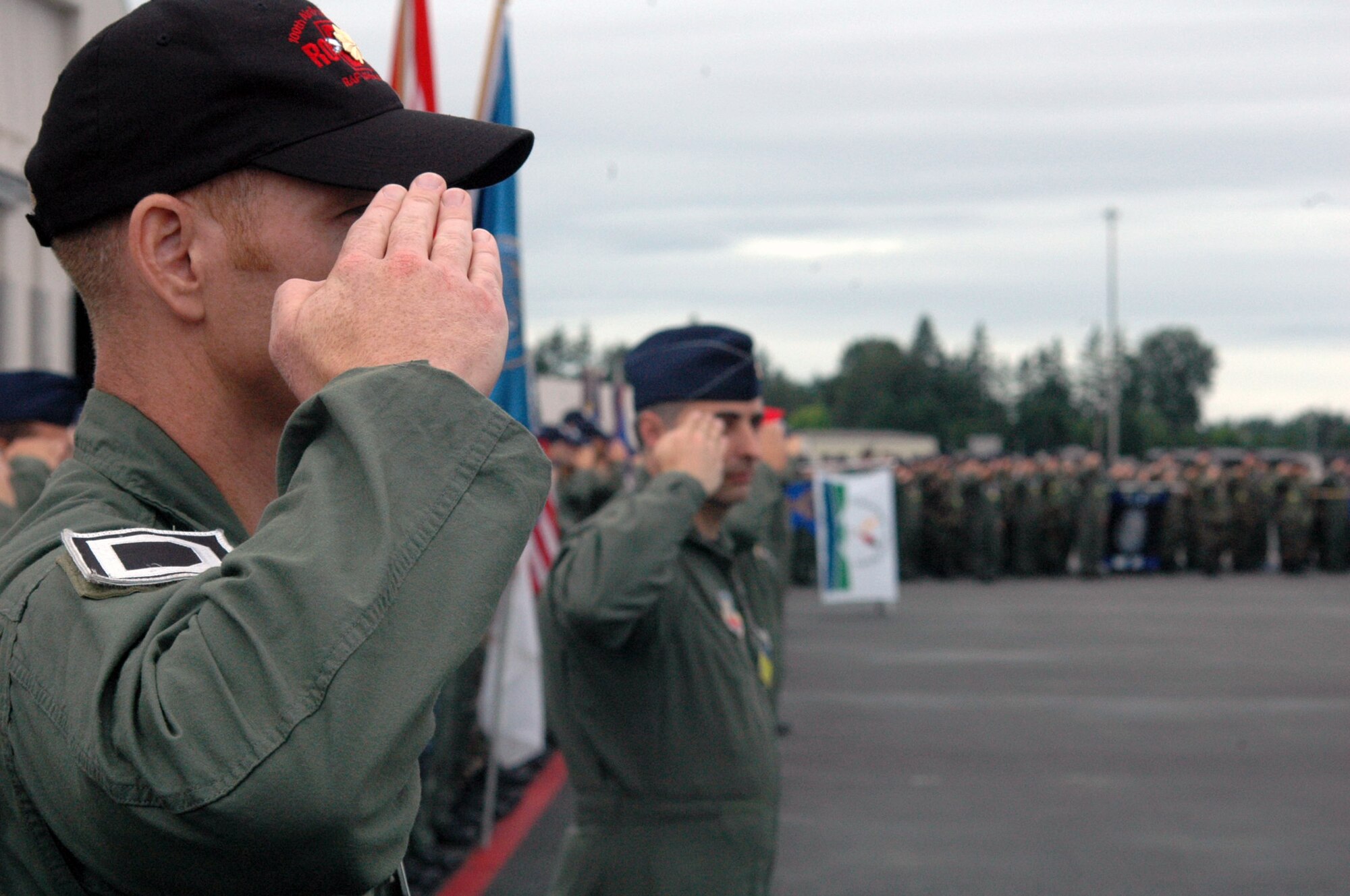 Teams participating in Air Mobility Rodeo 2007 salute at the playing of the U.S. national anthem during the opening ceremony for Rodeo at McChord Air Force Base, Wash., July 22.  Rodeo, sponsored by Air Mobility Command, is a readiness competition for U.S. and international mobility air forces.  (U.S. Air Force Photo/Tech. Sgt. Scott T. Sturkol)